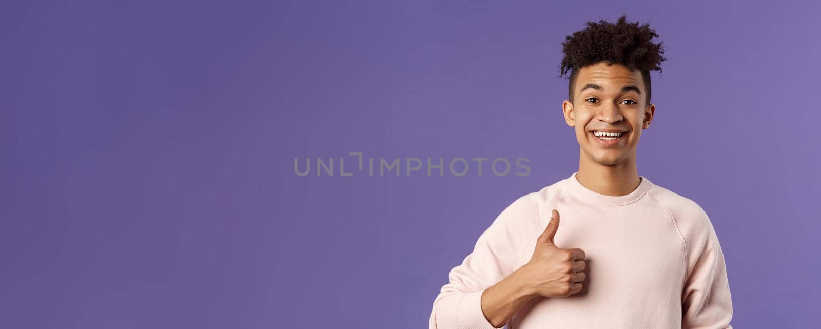 Close-up portrait of satisfied young smiling man recommend something really good, show thumbs-up in approval, like and agree with perfect choice, leave positive feedback, smiling happy by Benzoix