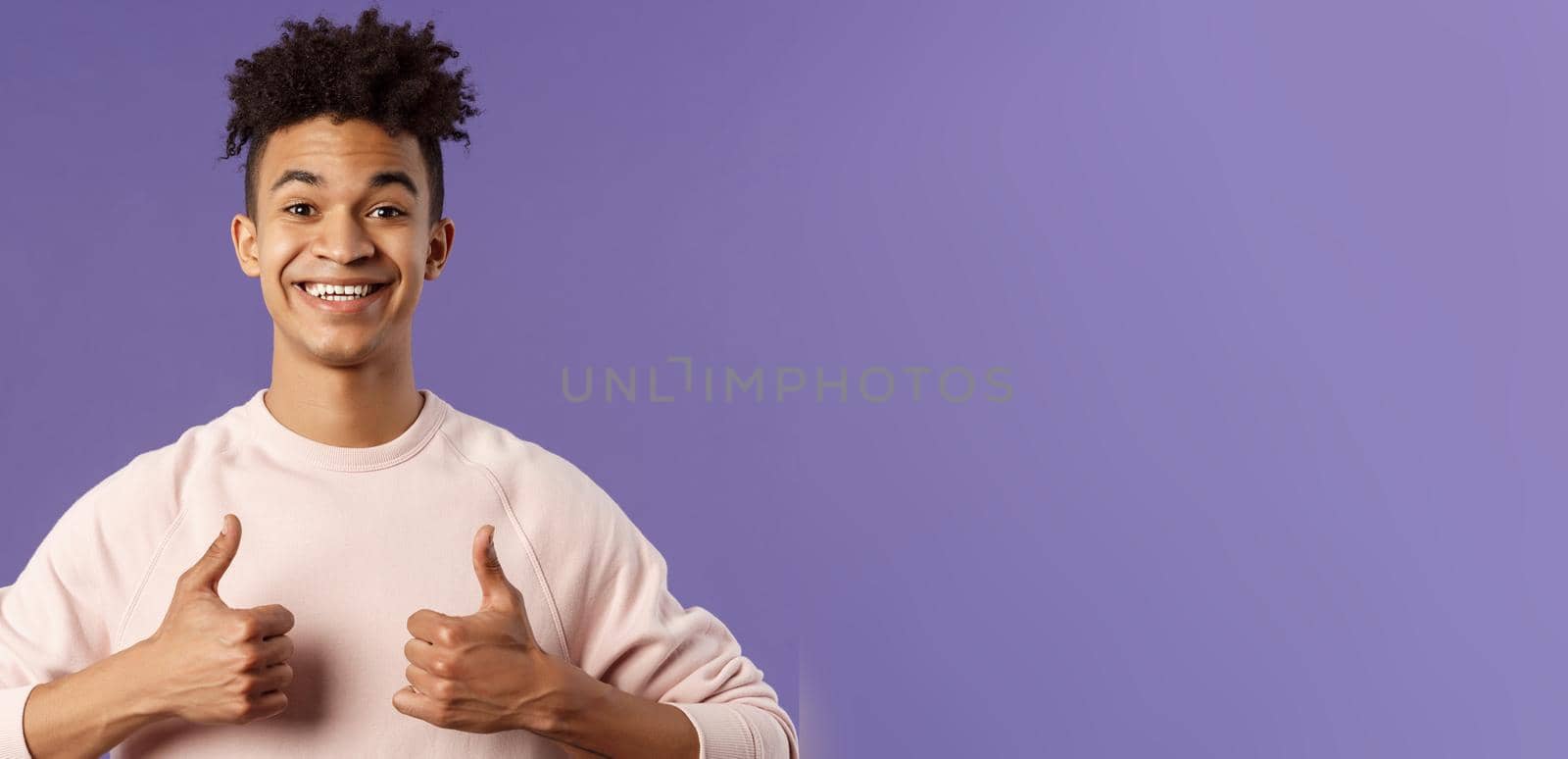 Close-up portrait of enthusiastic handsome young teenage guy, college student recommend awesome courses, online education school, show thumbs-up as recommending, like and approve, smiling.