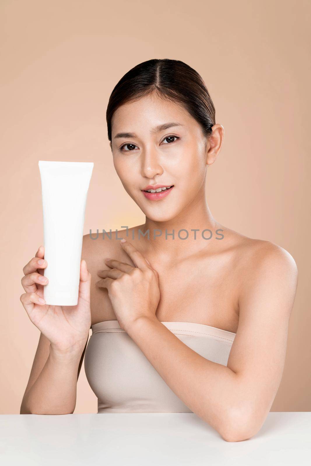 Ardent woman smiling holding mockup product for advertising text place. by biancoblue