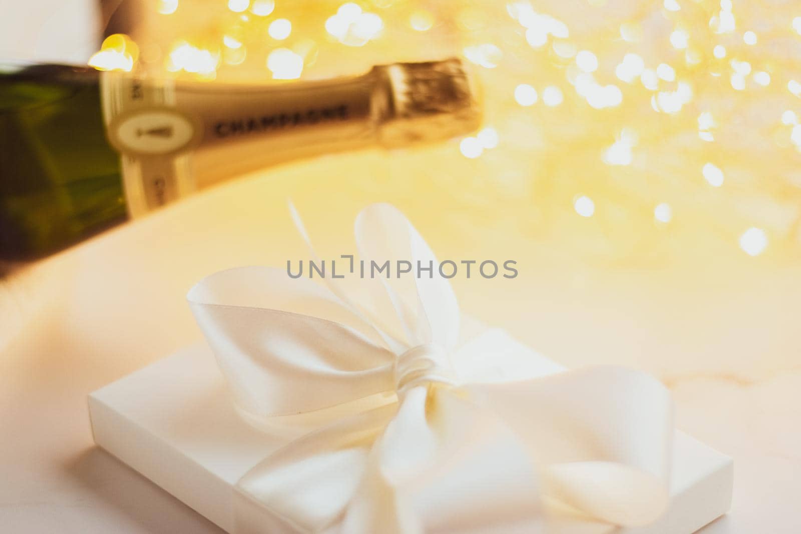 Romantic celebration, lifestyle and luxury present concept - The bottle of champagne and holiday gift box