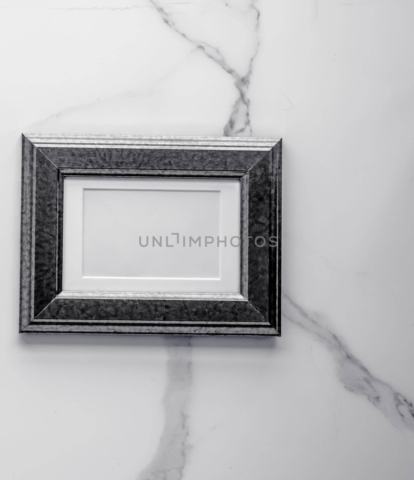 Black photo frame on marble, flatlay by Anneleven