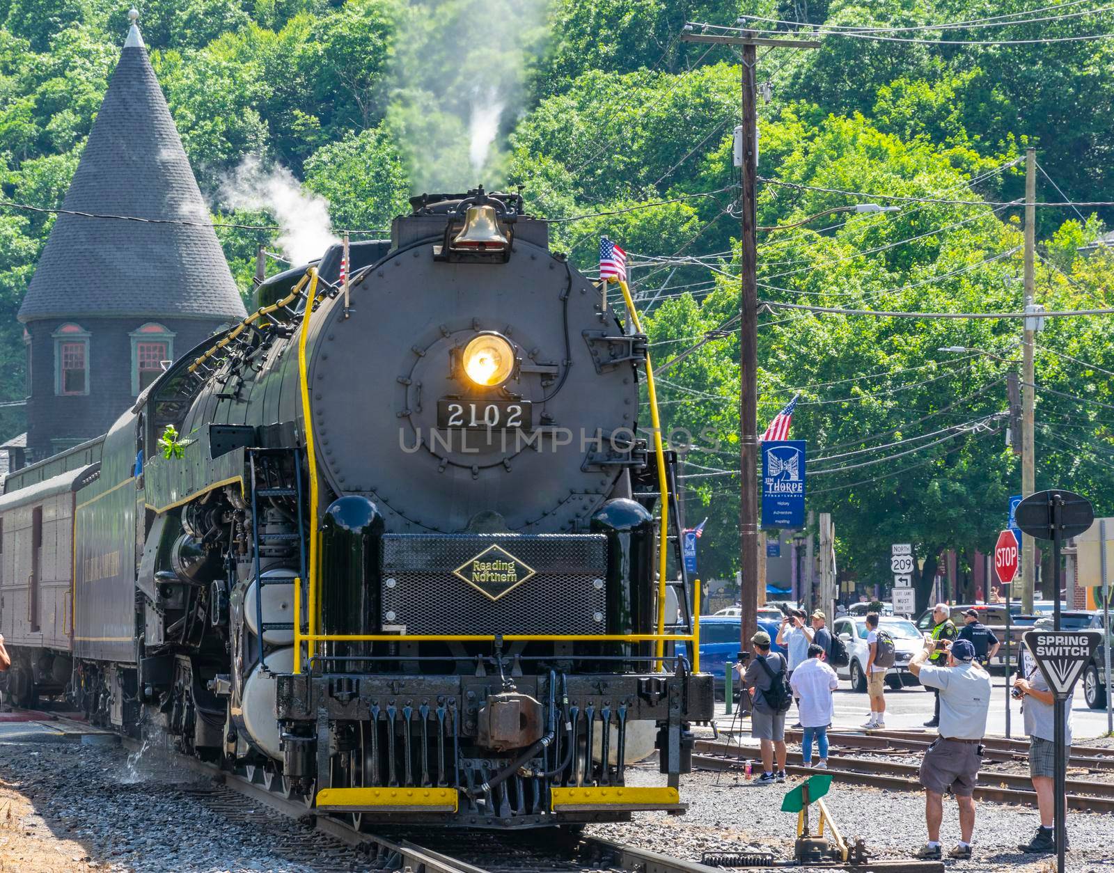 Ronks, Pennsylvania, November 8, 2021 - A View of a Restored Steam Freight Train Blowing Smoke and Steam Traveling Along a Rural Countryside on a Sunny Day
