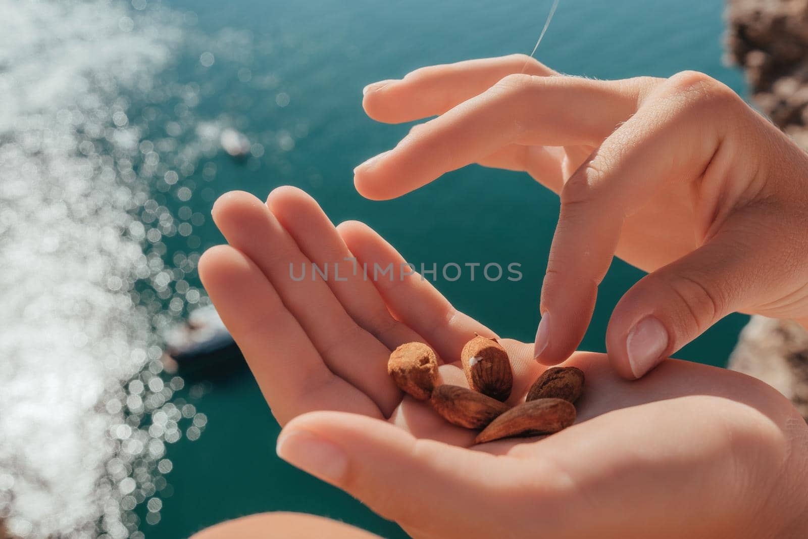 Unrecognizable caucasian woman eating young milky almond nuts. Healthy vegan food