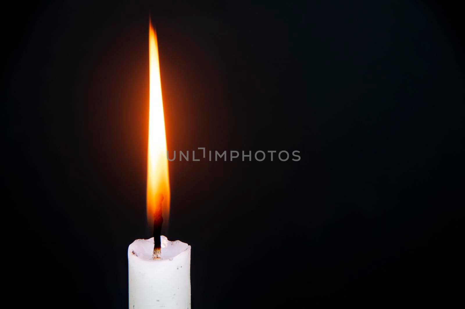 Candle light burning brightly with customizable space for text or ideas. Copy space.