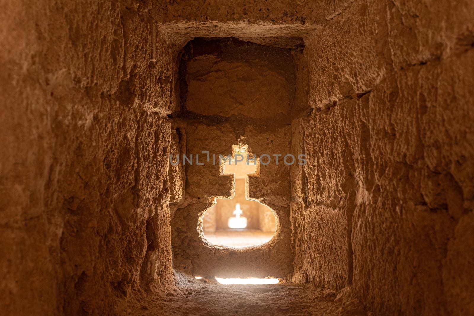 Perspective view of entrance passage carved in form of divine cross in ancient stone cave of Citadel of Almeria city in Spain