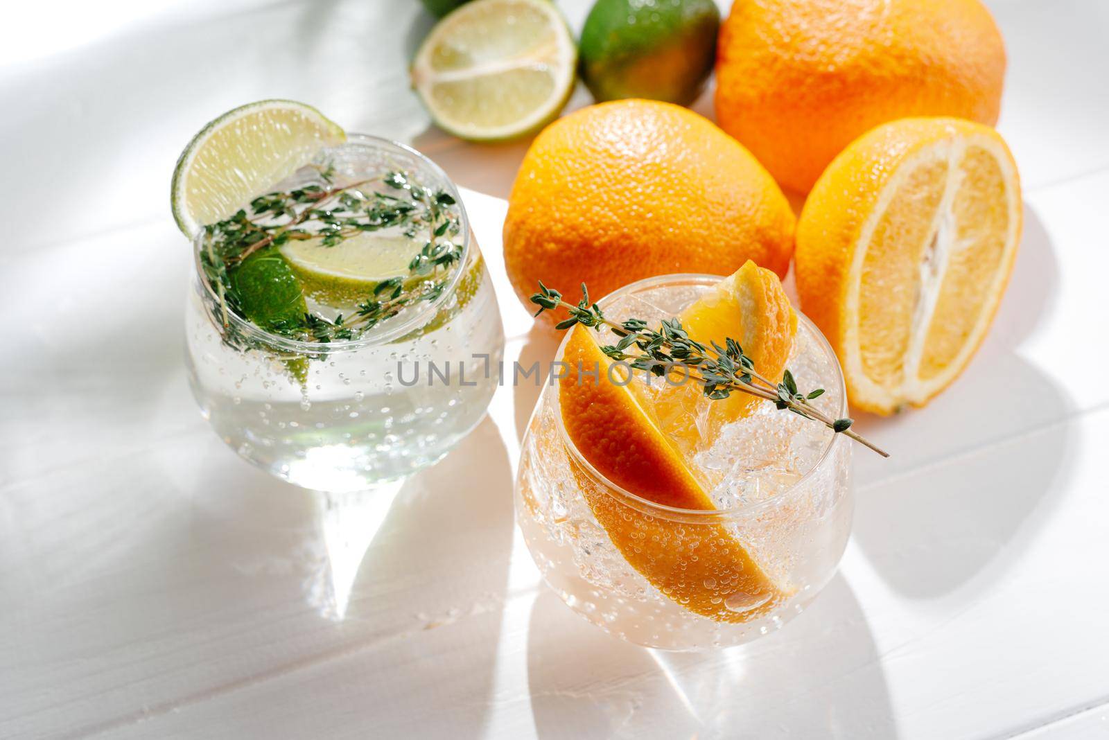 Strong seltzer cocktails with lime and Hard seltzer cocktails Alcoholic beverage with tonic and orange on a light background. Top view.