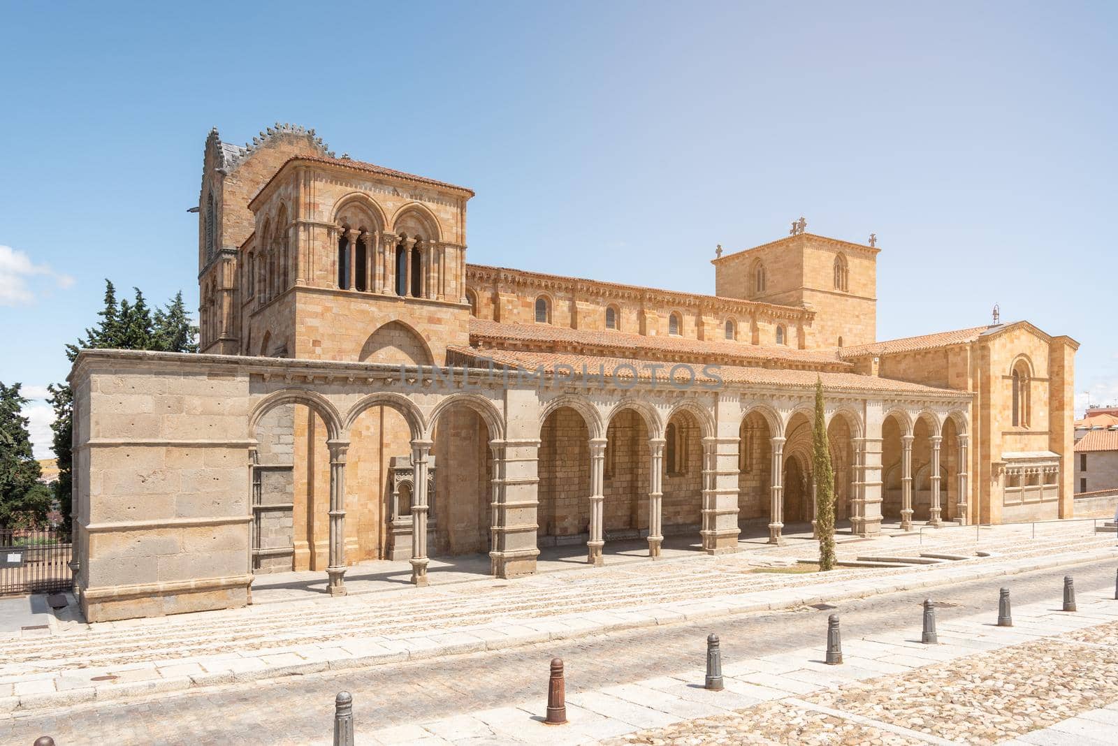 Amazing scenery of Basilica of San Vicente with arched passages and windows located in Avila city on sunny day under blue sky