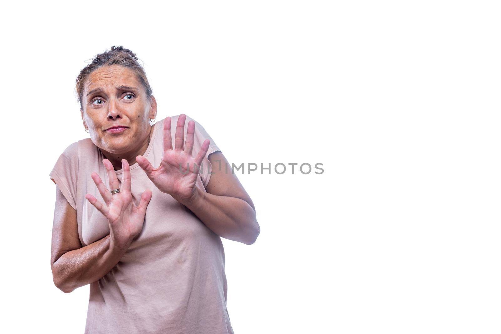 Front view of a scared green-eyed woman on a white background with copy space.