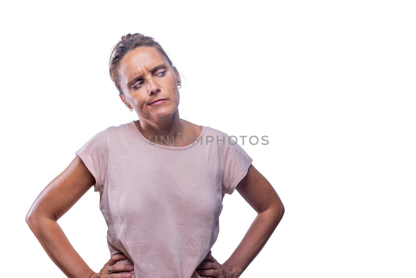 Front view of a suspicious adult woman looking to a side on a white backgroundwith copy space.