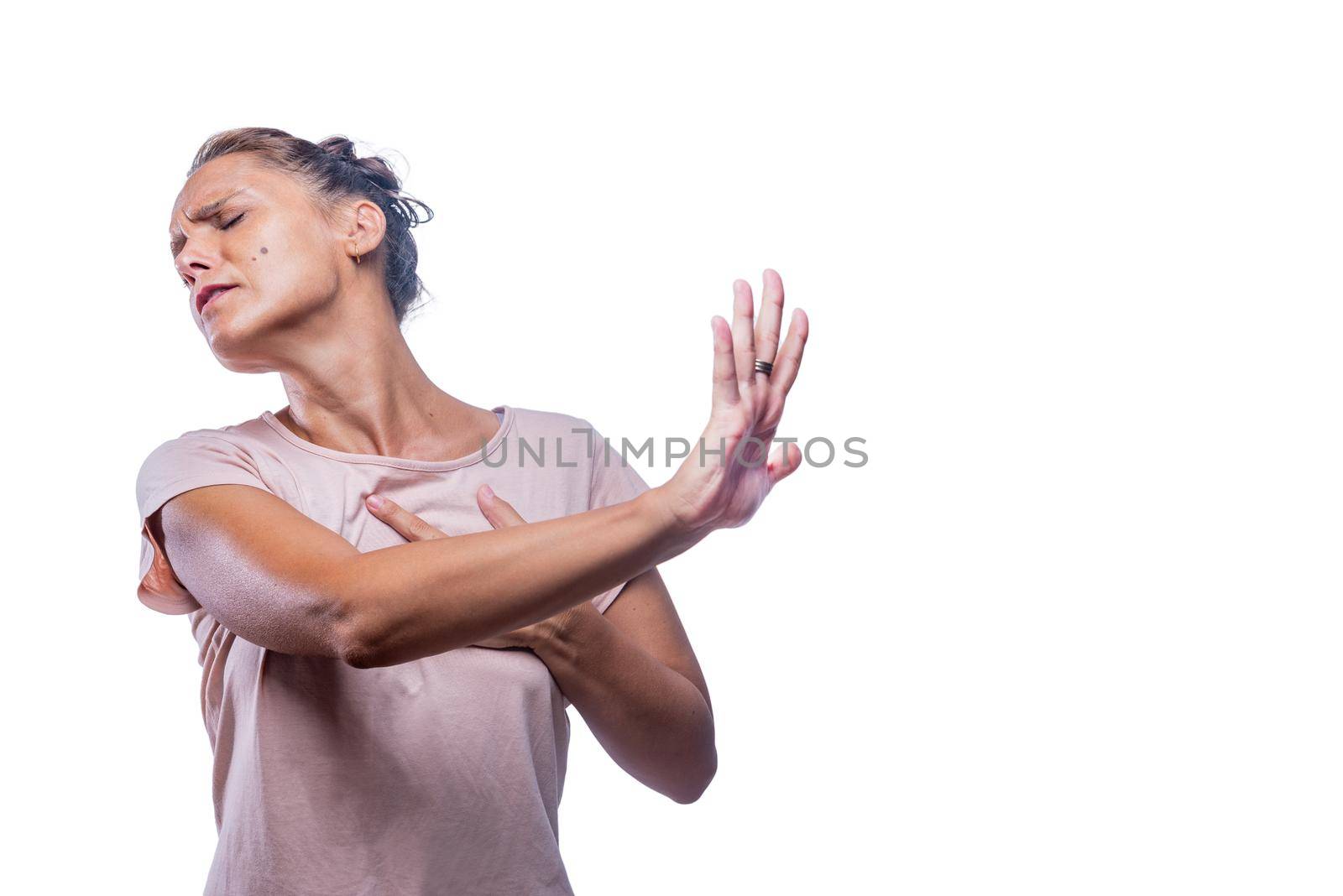 Front view of a displeased woman frowns face and show palm in discontent on a white background with copy space.