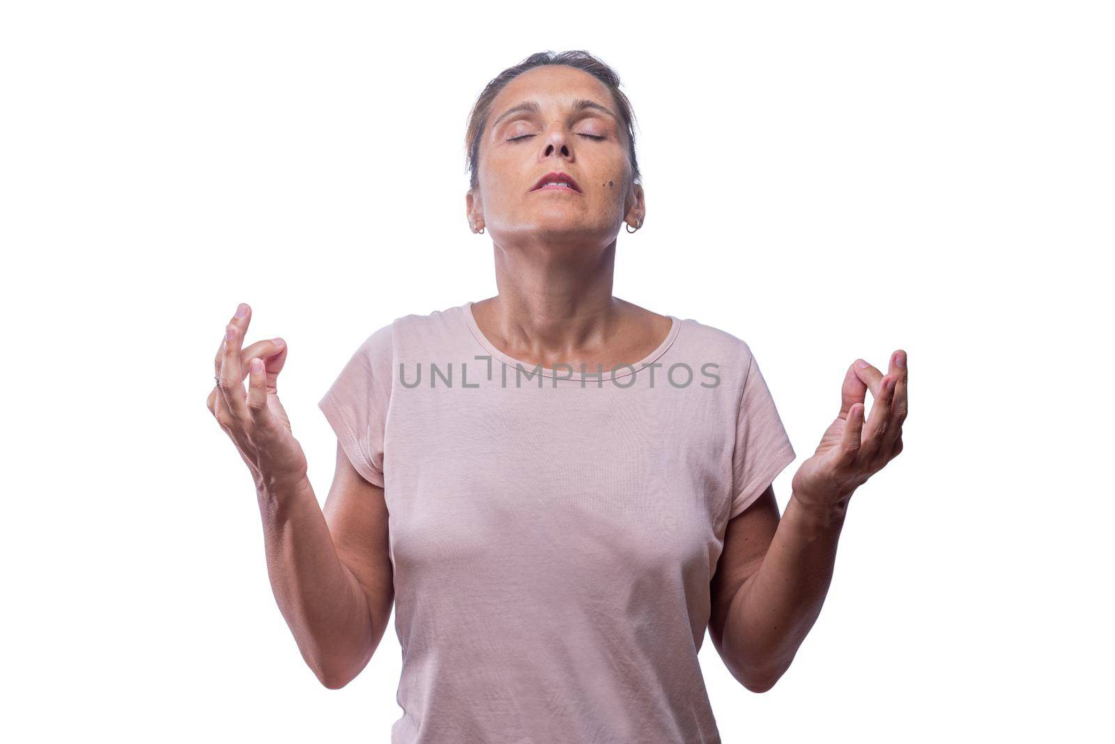 An adult woman standing meditating on a white background by ivanmoreno