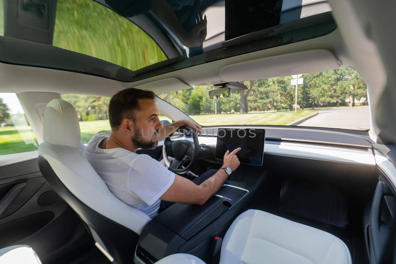 Caucasian man driving a modern electric car