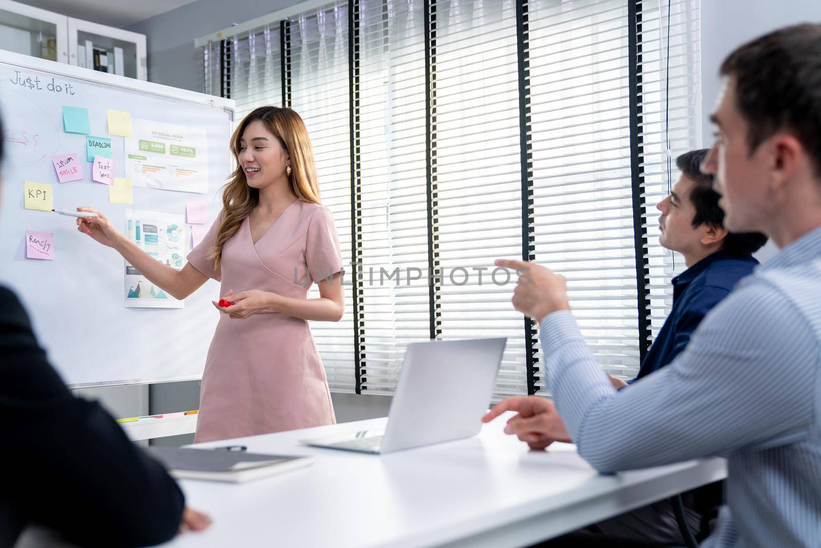 Competent office workers from various nationalities are debating, discussing and brainstorming in the meeting room. A group of employees is collaborating to achieve their business objectives.