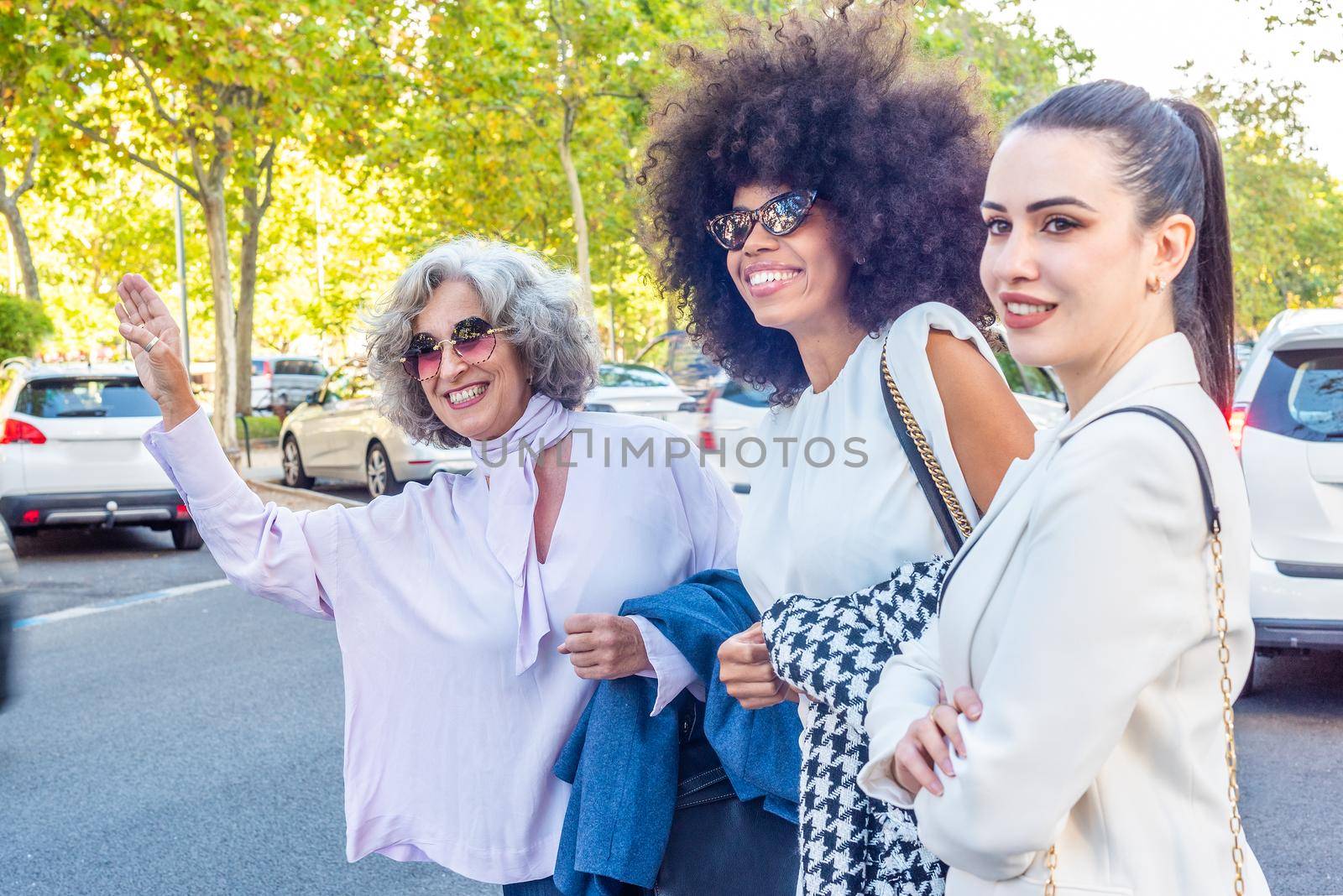 three businesswomen waiting for a taxi after a working day, horizontal portrait