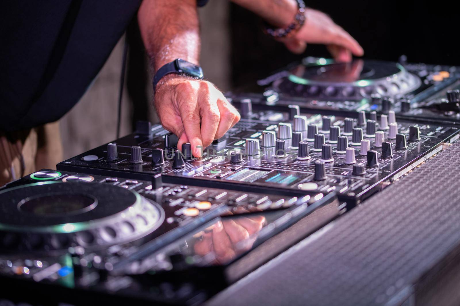 Dj playing disco house progressive electro music at the concert. DJ hands on equipment