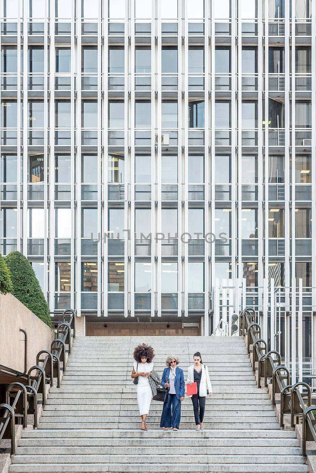 women entrepreneurs walking down the stairs after work by ivanmoreno