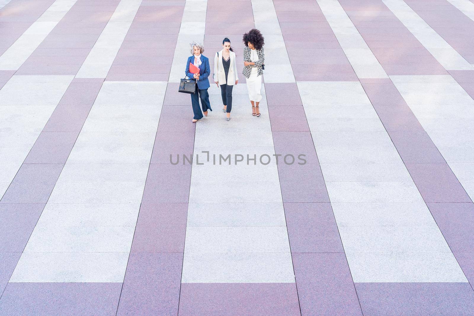front view of three women in suits on a flagstone floor, horizontal alternate pattern