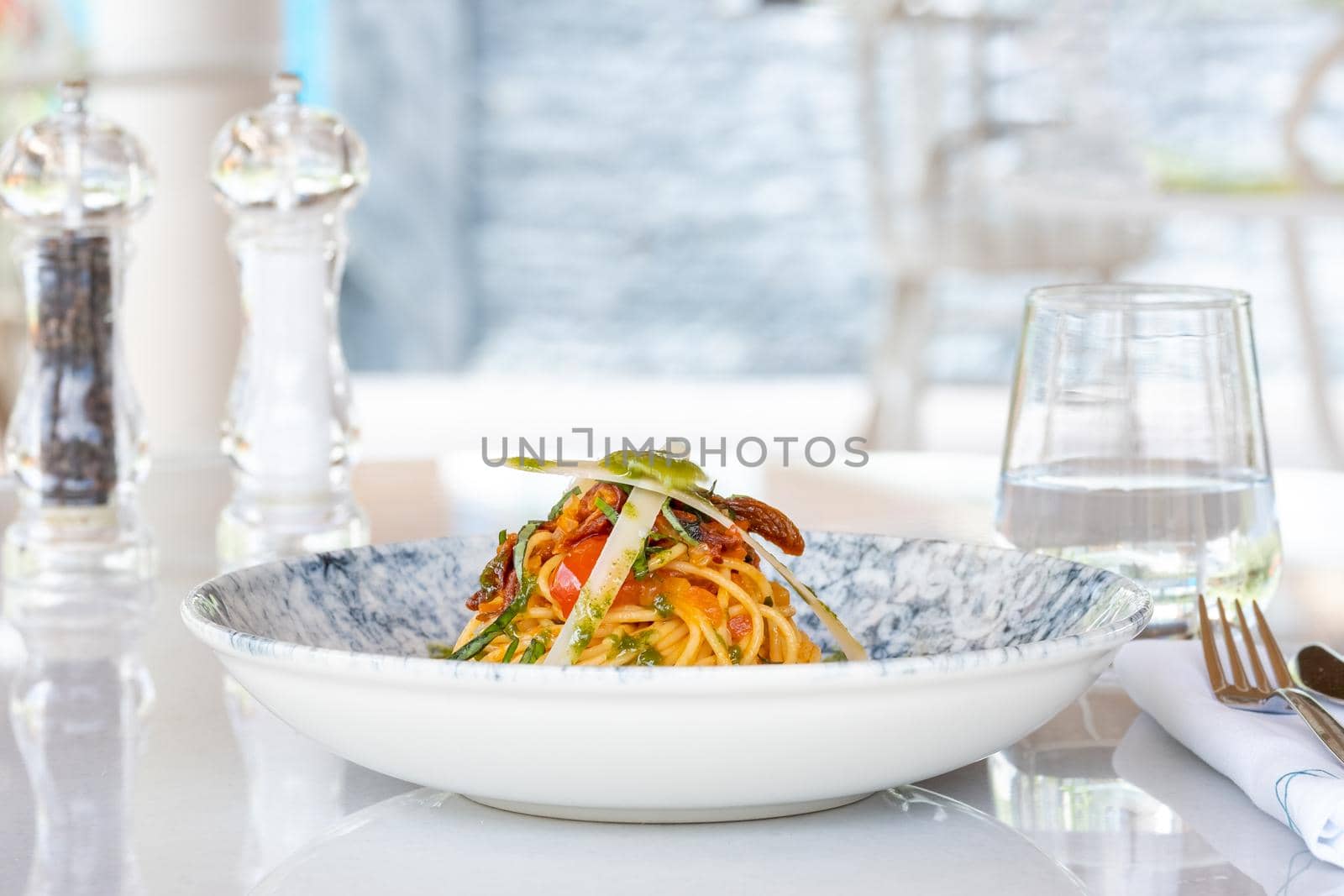 Spaghetti with a spicy sauce, chili pepper and grated parmesan cheese by Sonat