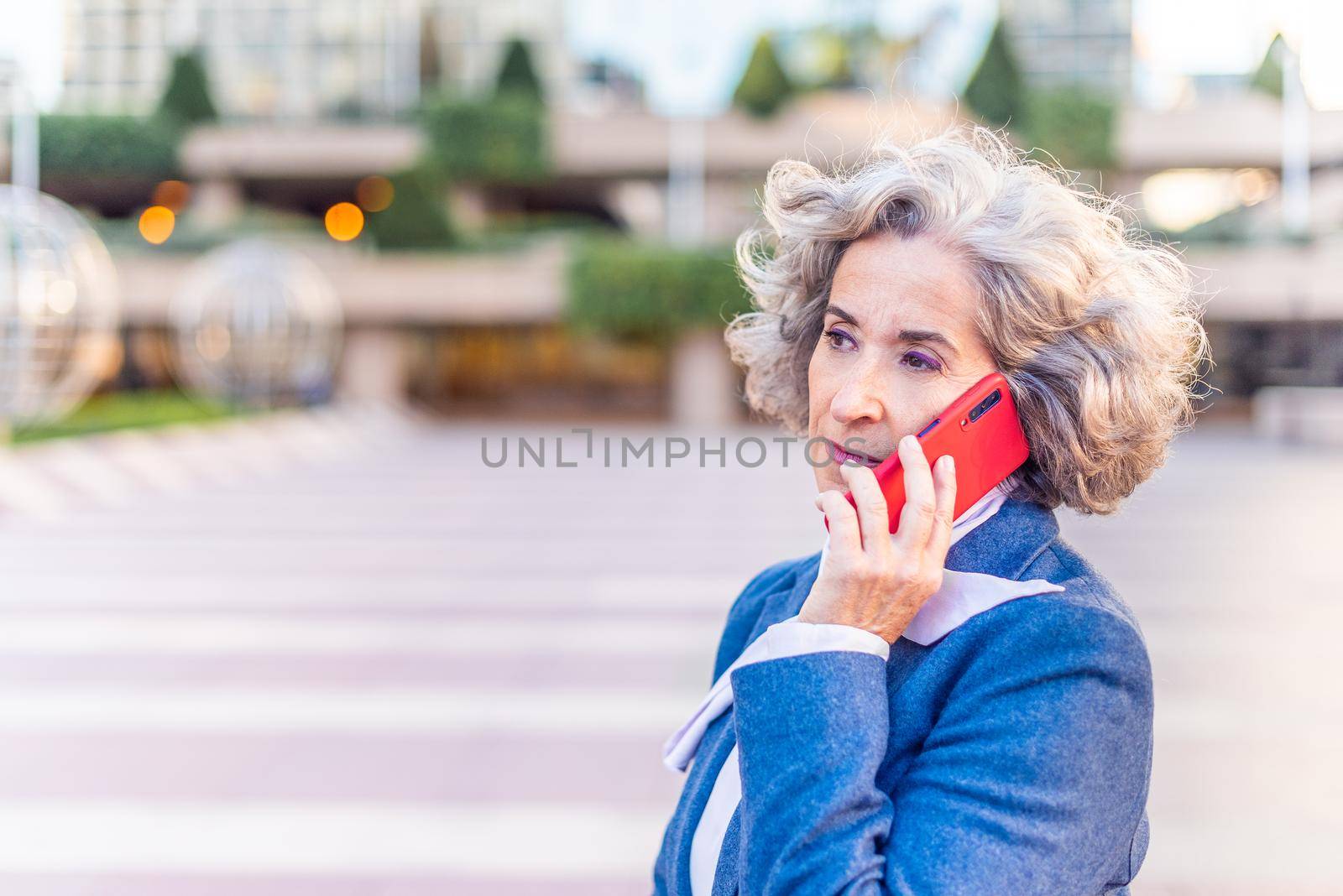 executive woman talking business on the phone, horizontal close-up