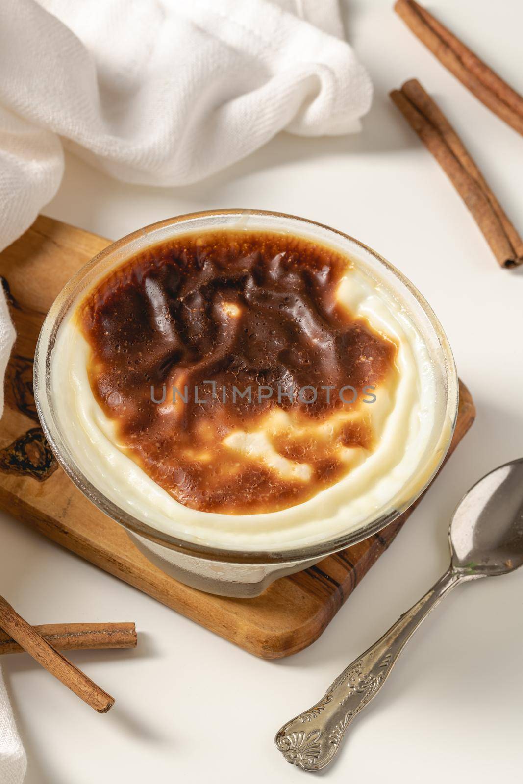 Traditional turkish dessert bakery rice pudding Turkish name Fırın Sutlac in glass bowl by Sonat