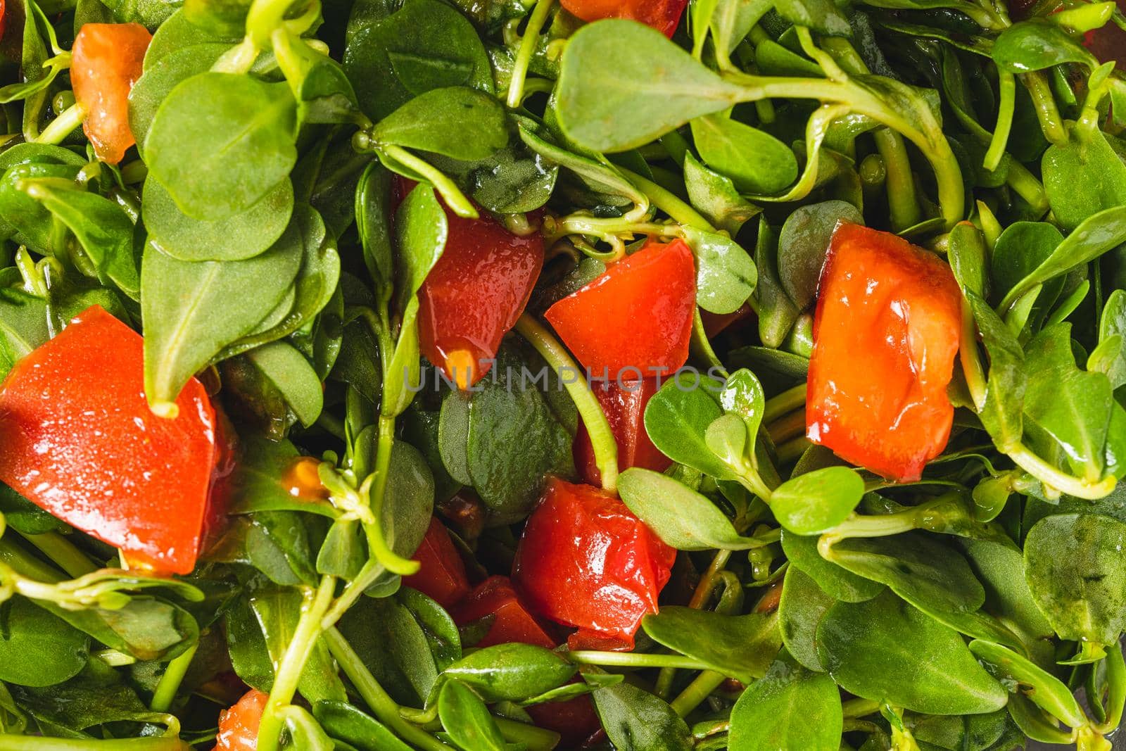 Purslane salad with tomatoes in a glass bowl. Healthy eating concept by Sonat