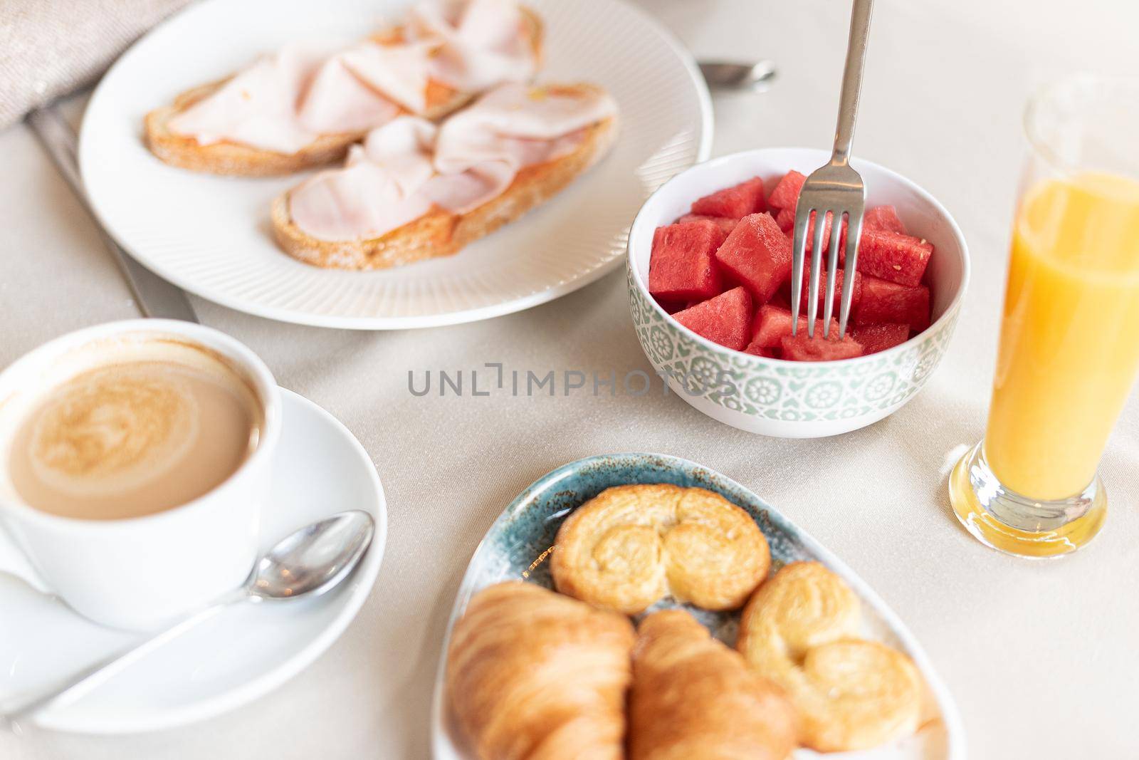 Close up view of a breakfast served at a table in a hotel dining room. Concept of breakfast in hotel.