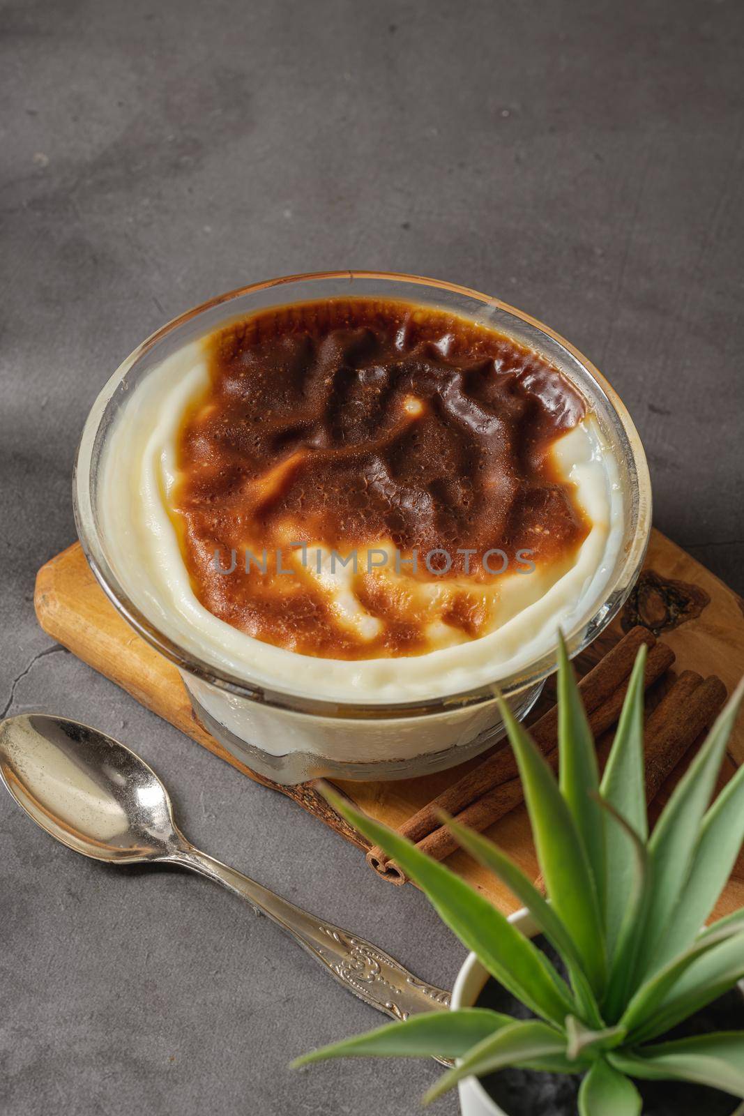 Traditional turkish dessert bakery rice pudding Turkish name Fırın Sutlac in glass bowl by Sonat