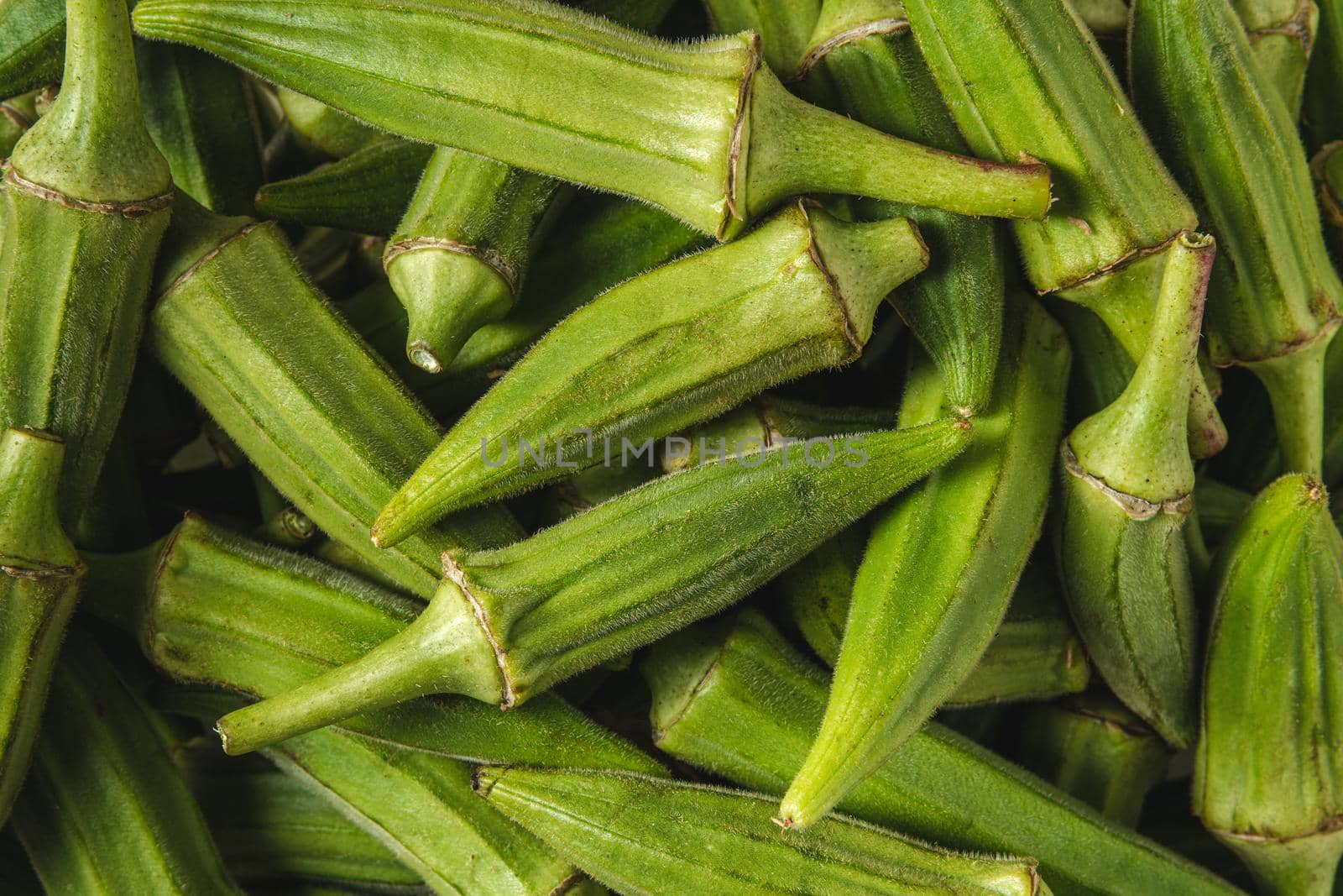 Fresh raw okra in a glass bowl. Healthy eating concept