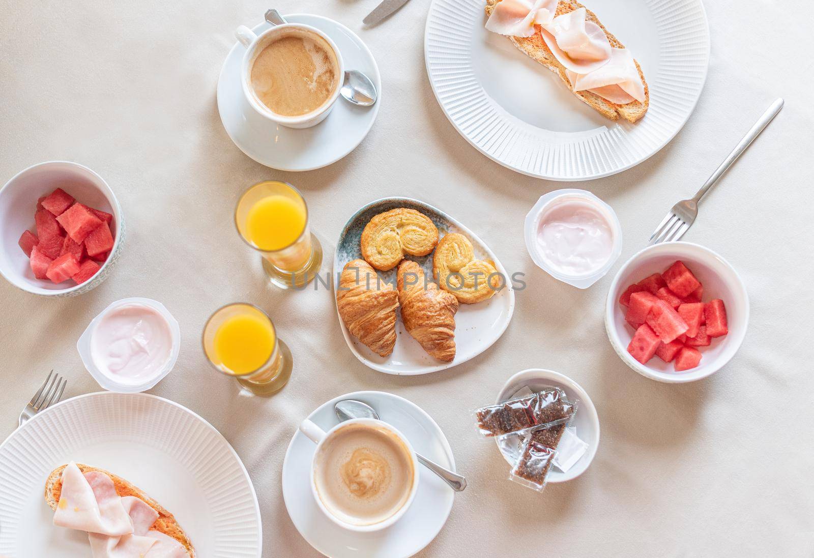 Top view of a full breakfast for two served at a table in a hotel dining room. Concept of breakfast in hotel.