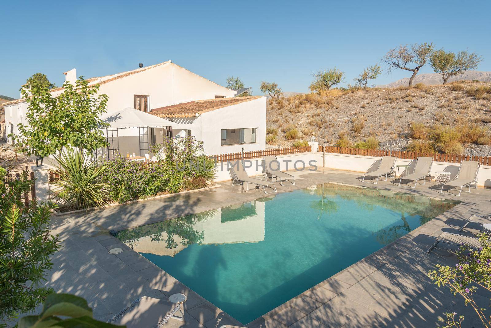 A rural hotel with swimming pool on a hill located in Almeria, Spain. Concept of tourism.