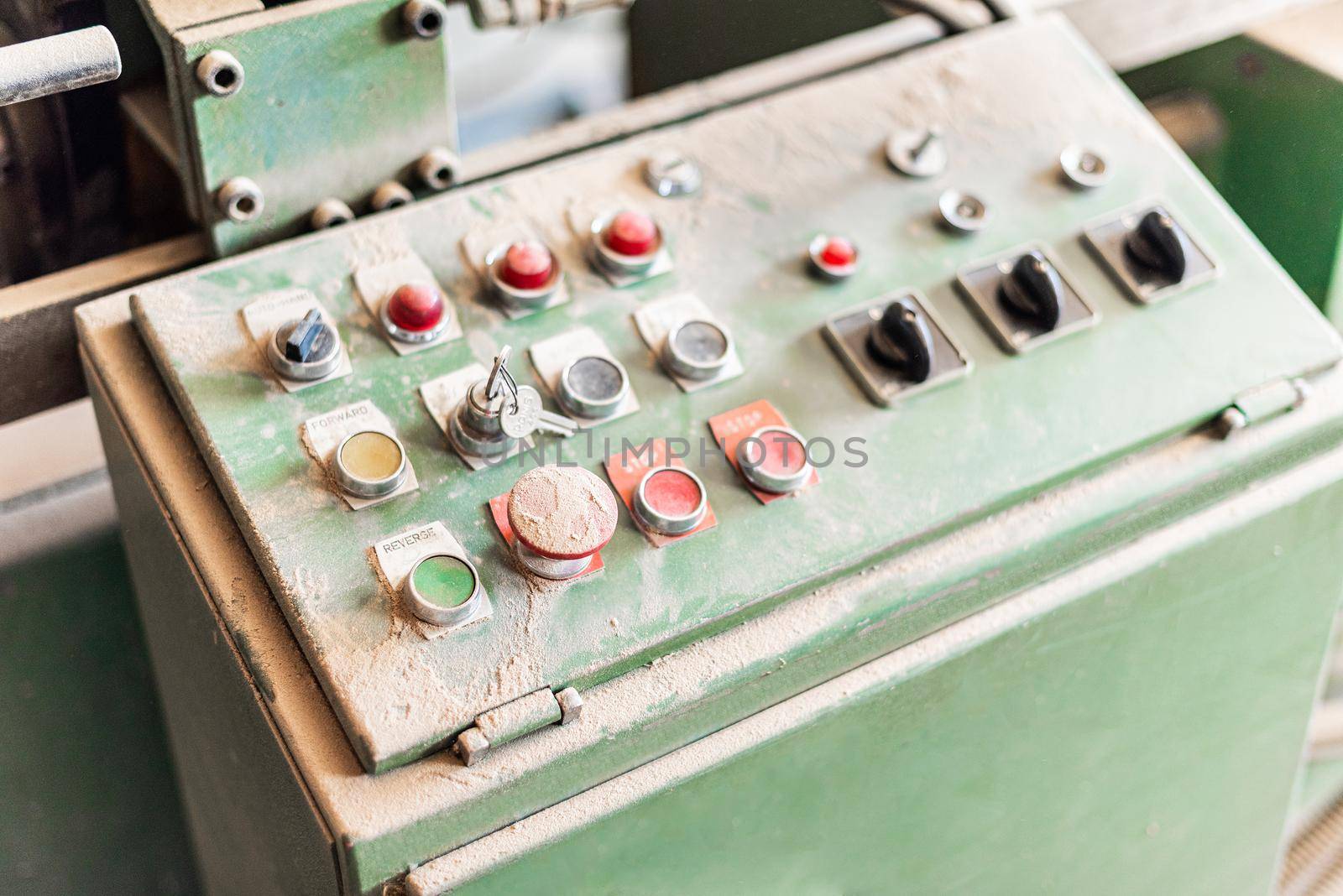 grey control panel with buttons and switches, close-up view