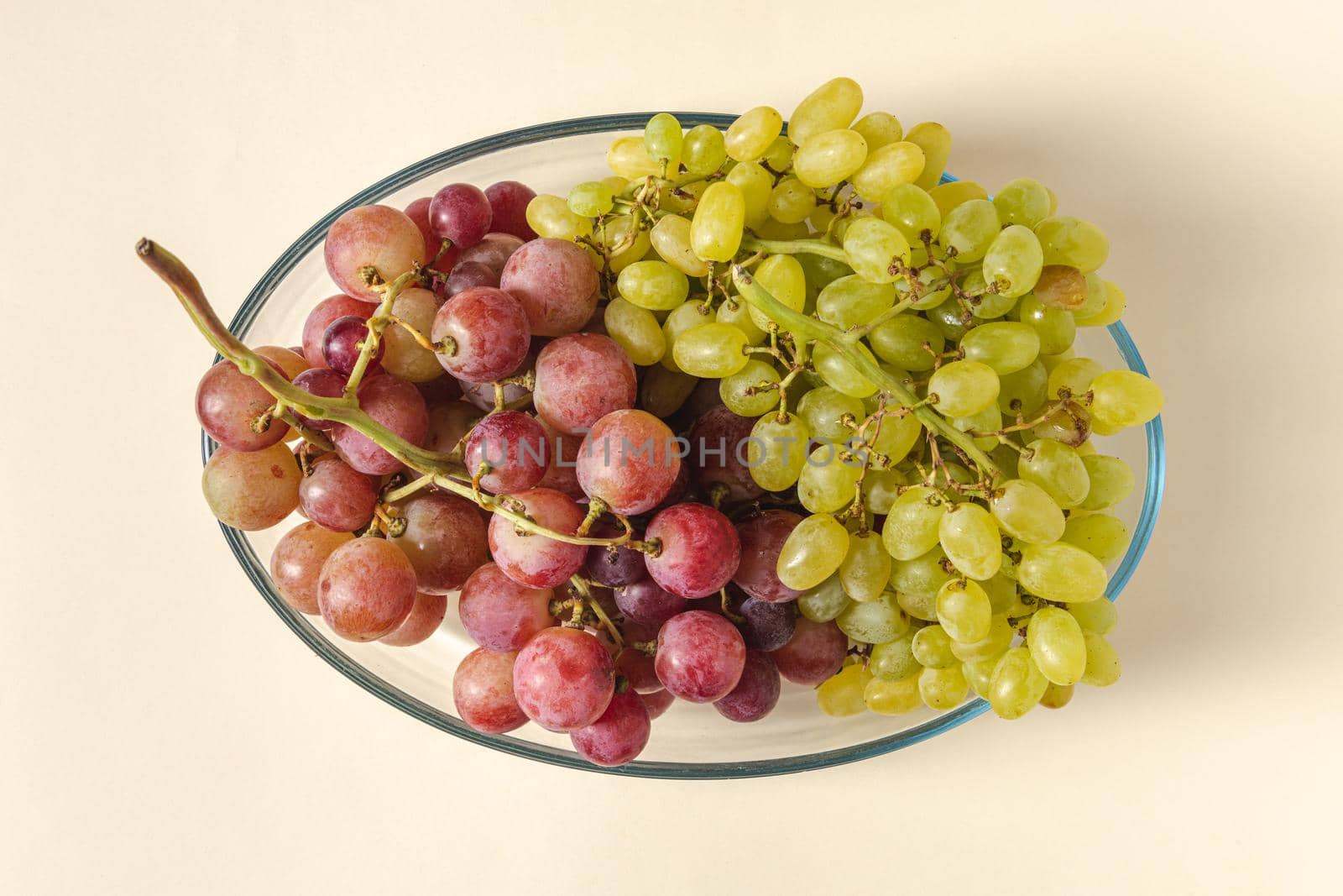Fresh red and green grapes in a glass bowl. Healthy eating concept