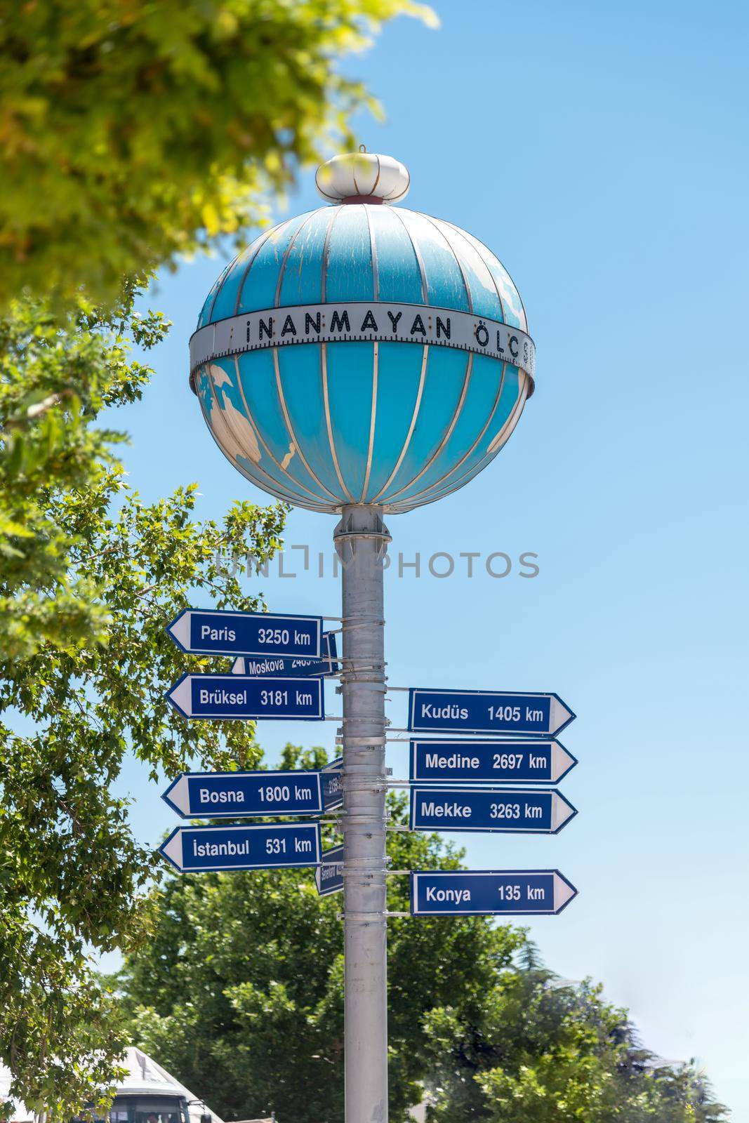 Aksehir, Turkey - July 04, 2022: Aksehir Nasreddin Hoca Square, the Infidel Measures Monument and the distance sign to different cities on it