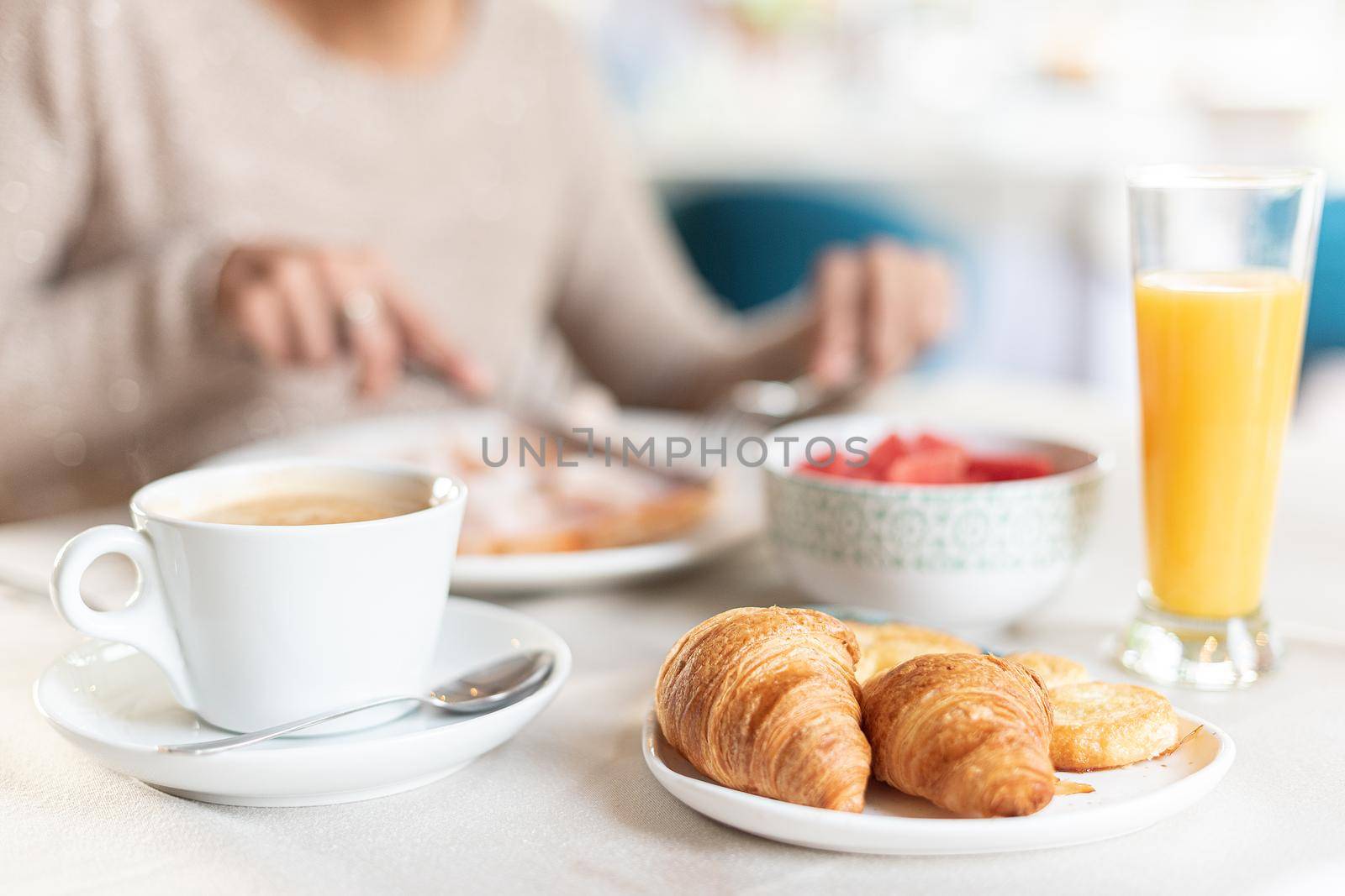 Coffee and croissant for breakfast in a table in a hotel dining room. Concept of breakfast in hotel.