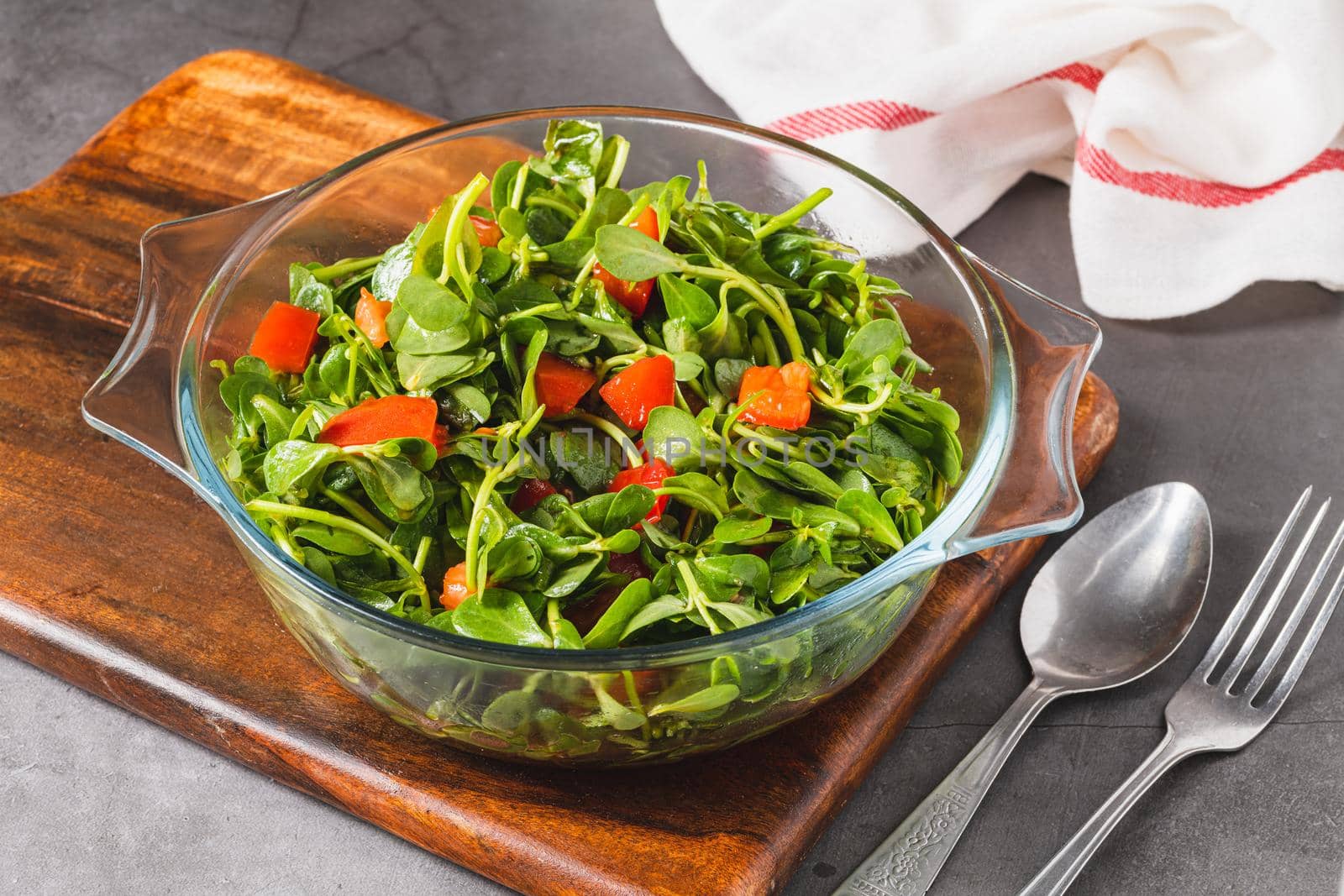 Purslane salad with tomatoes in a glass bowl. Healthy eating concept by Sonat