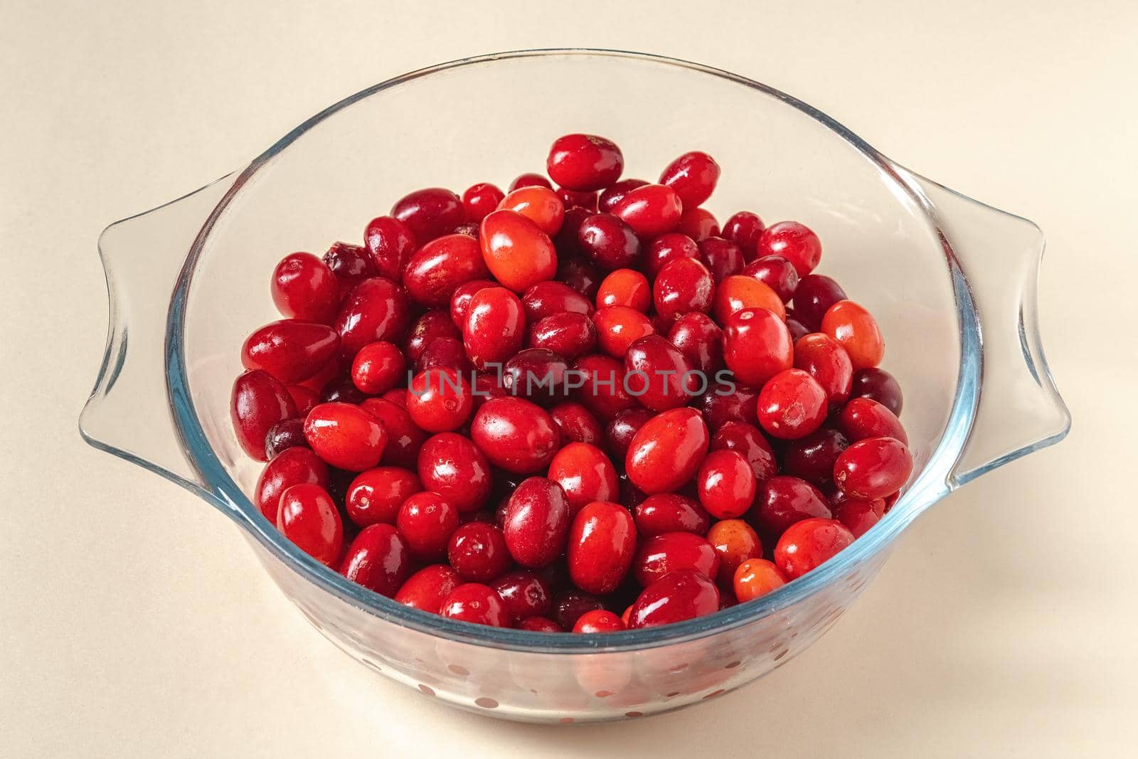 Fresh cranberries in a glass bowl. Healthy eating concept by Sonat