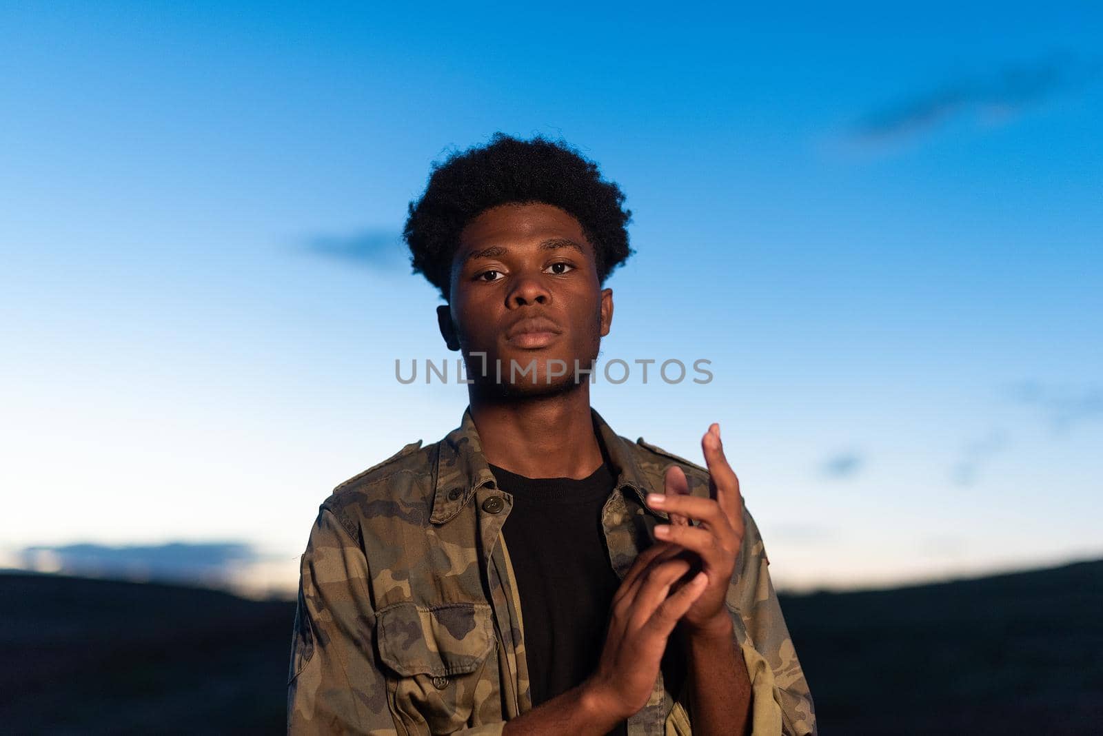 Close up portrait of an african young man with confident attitude during dusk outdoors