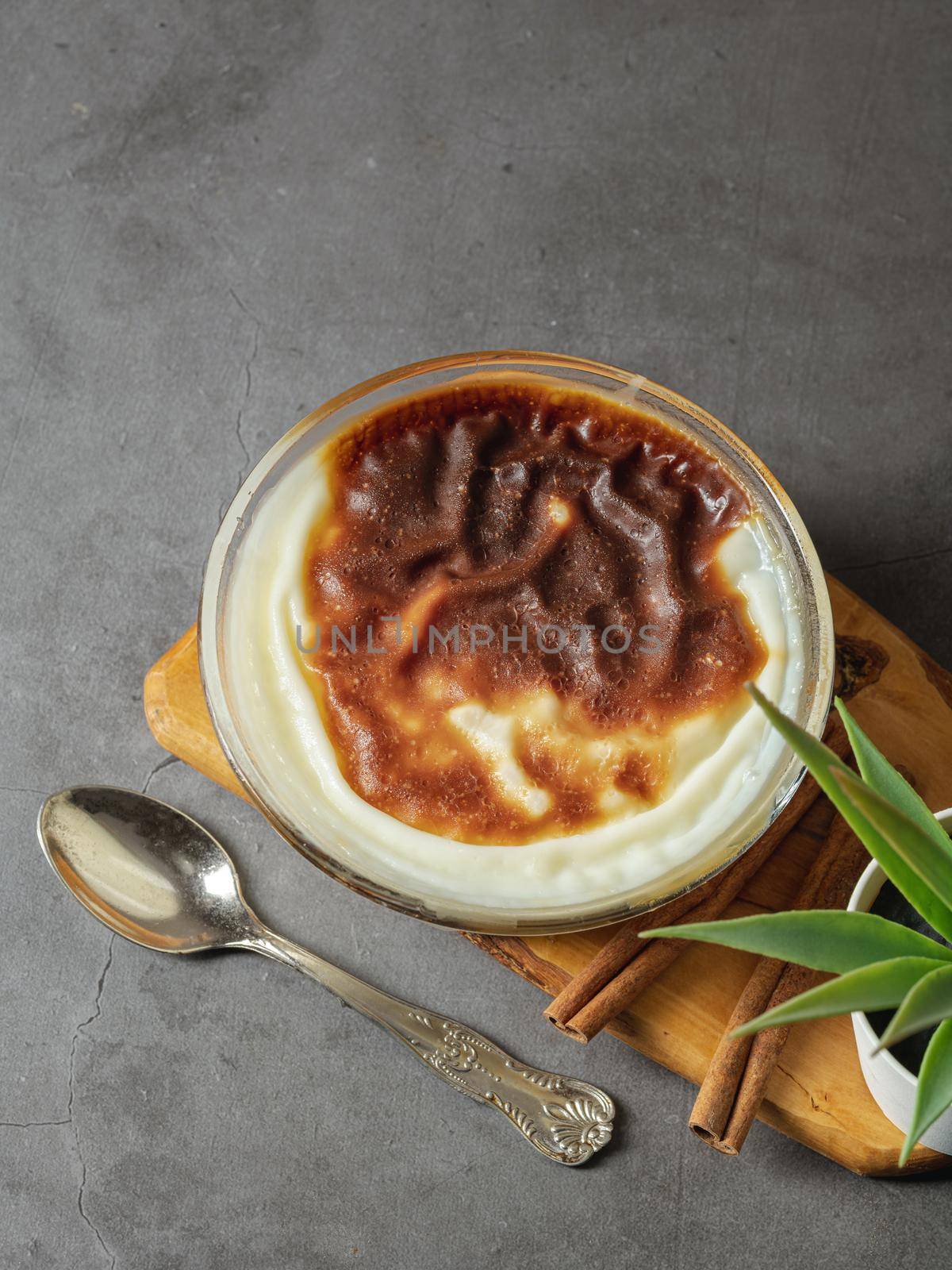 Traditional turkish dessert bakery rice pudding Turkish name Firin Sutlac in glass bowl by Sonat