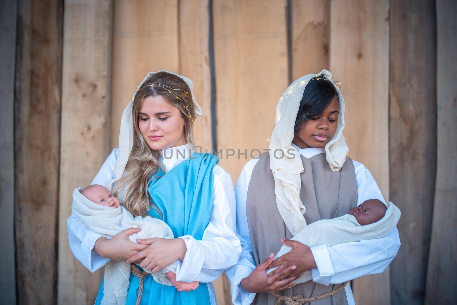 Representation of a nativity scene with two multiethnic lesbian Virgin Marys holding babies