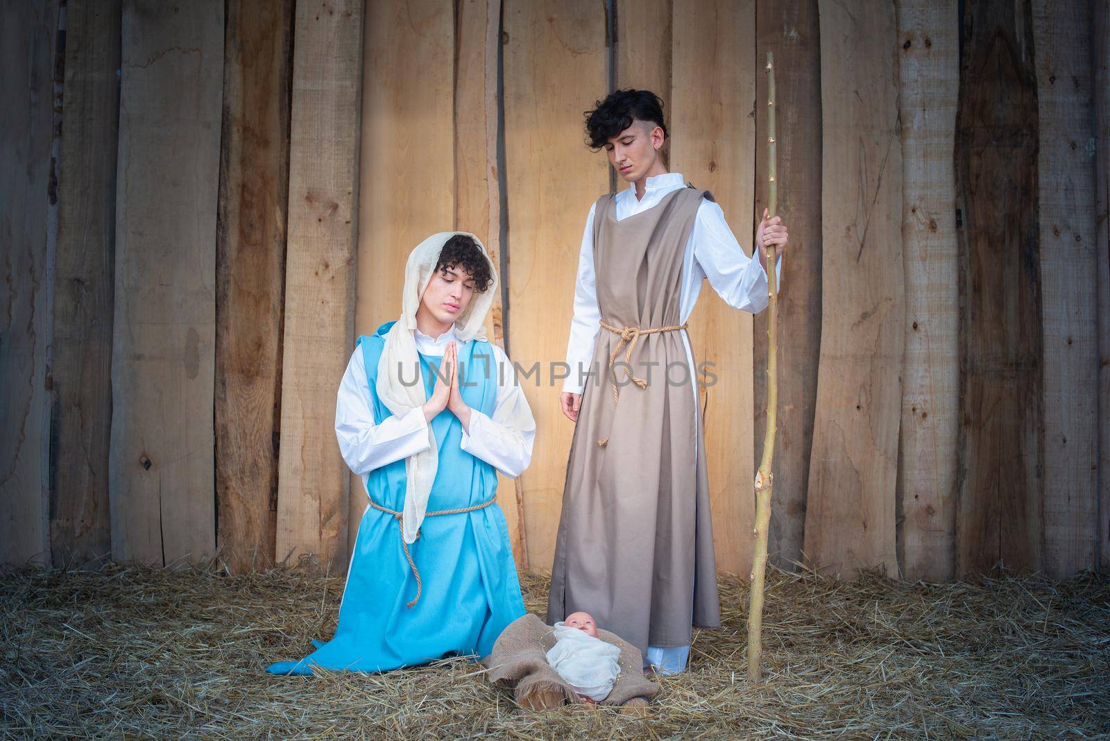 Characterization of a nativity scene with androgynous people representing the virgin mary and joseph