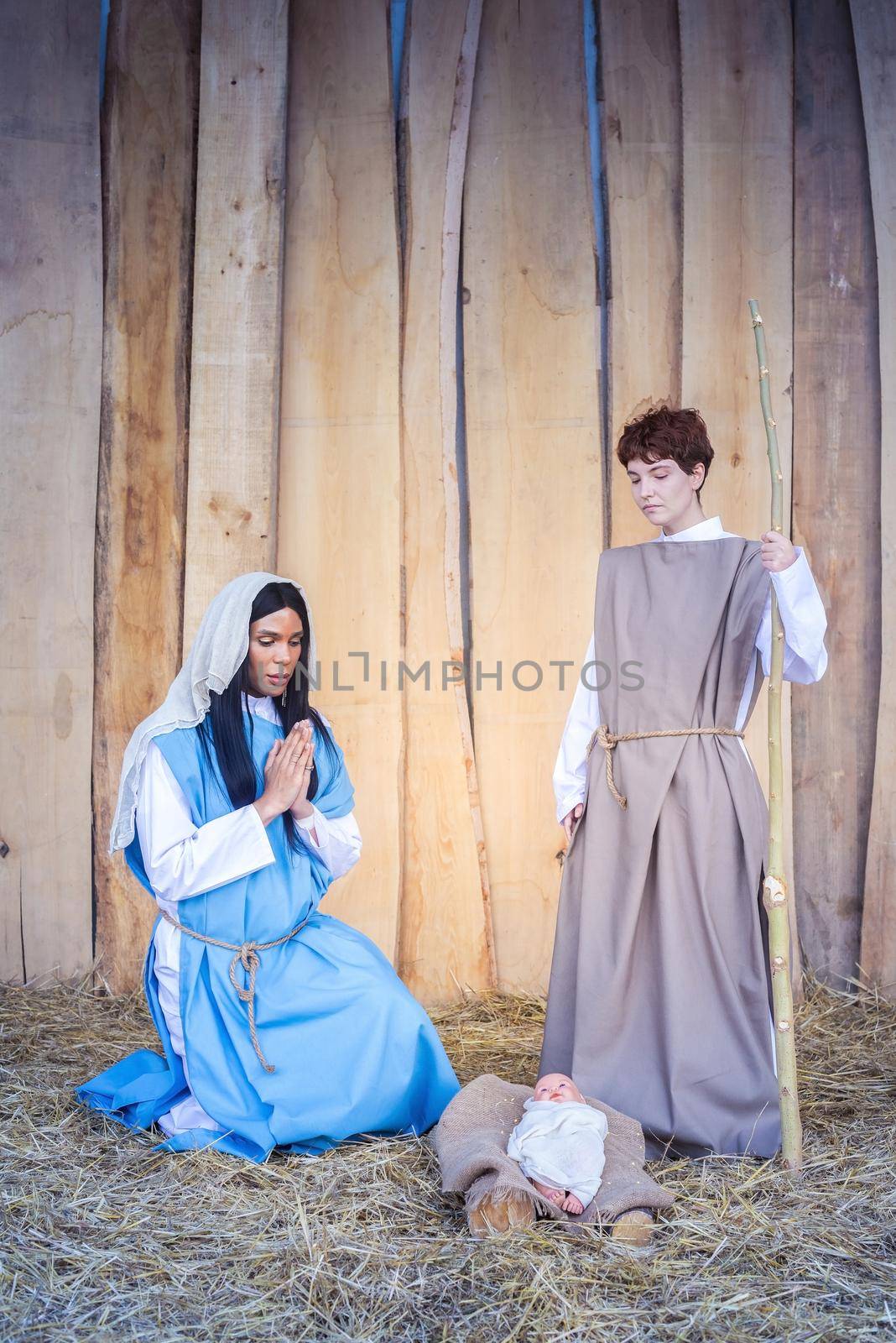 Vertical photo of the christmas crib with transgender people representing a scene of Mary and Joseph