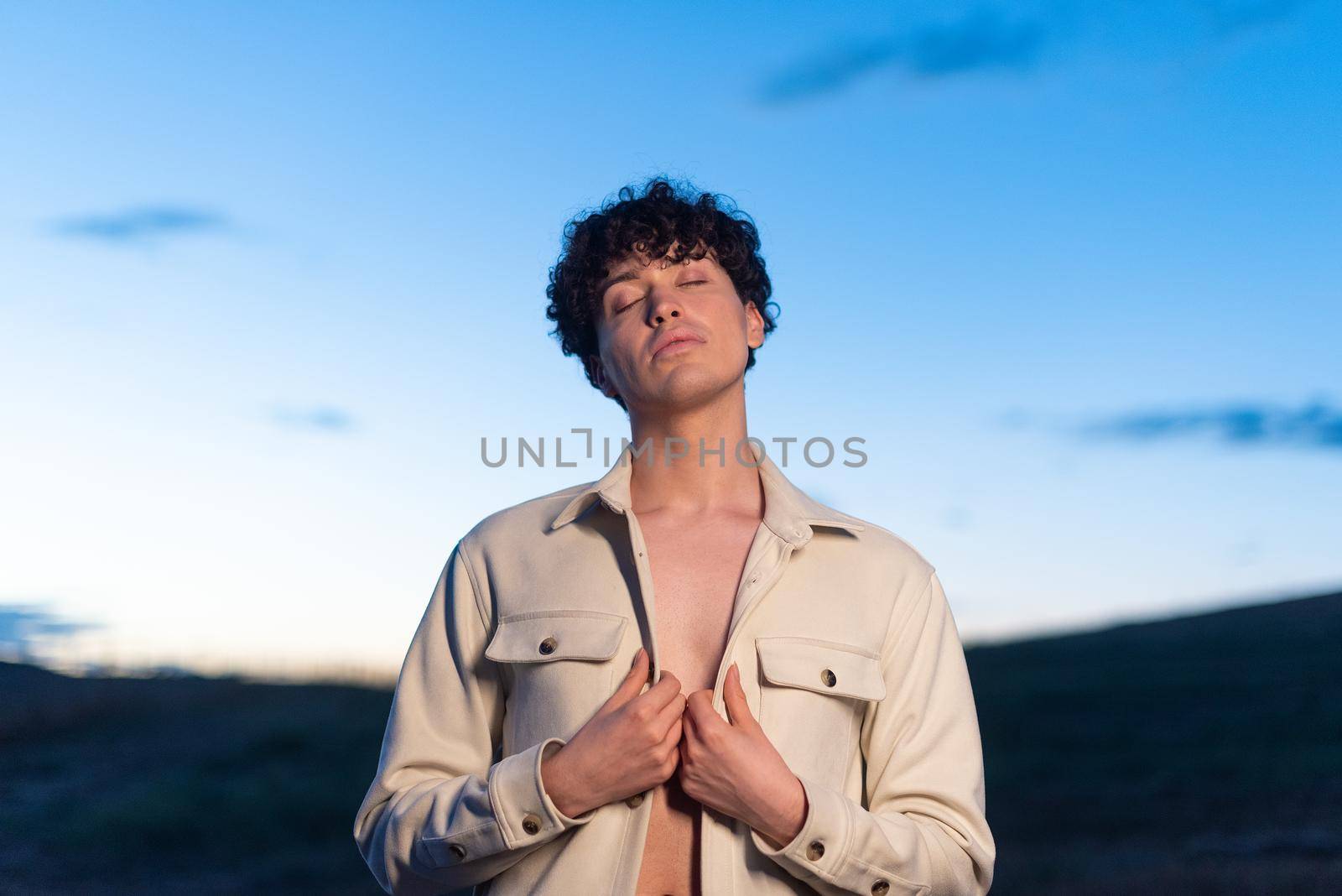 Portrait during dusk of a non binary male posing relaxed by ivanmoreno