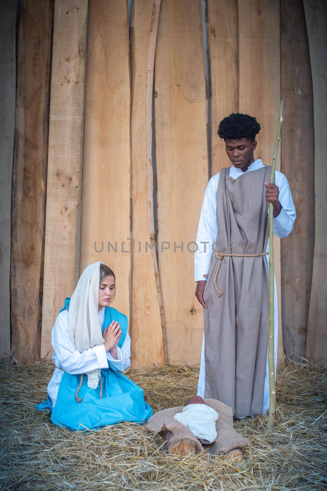 Vertical nativity scene with multi-ethnic characters in a crib by ivanmoreno