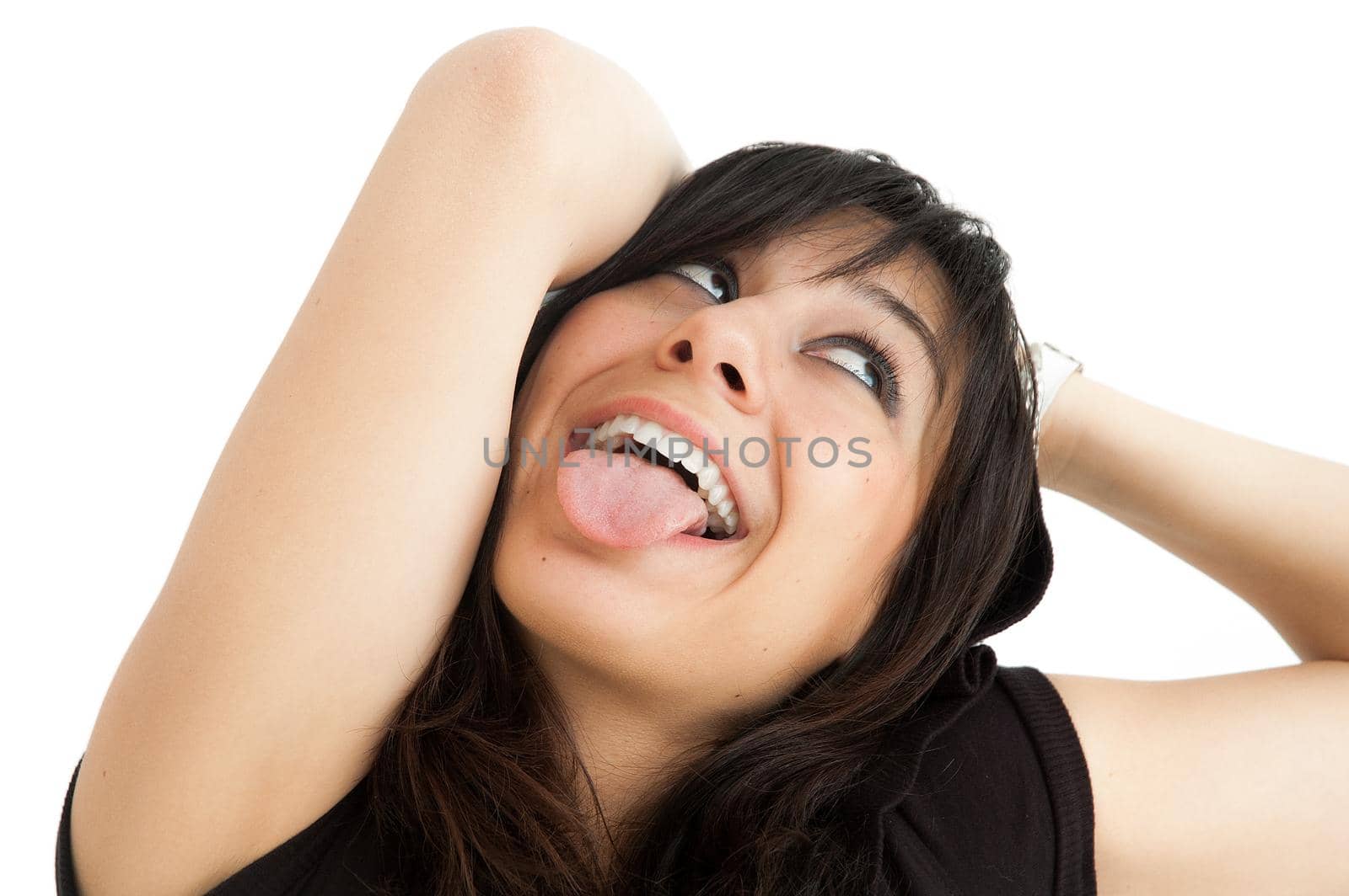 Close up studio portrait of a young caucasian woman grimacing in a white background