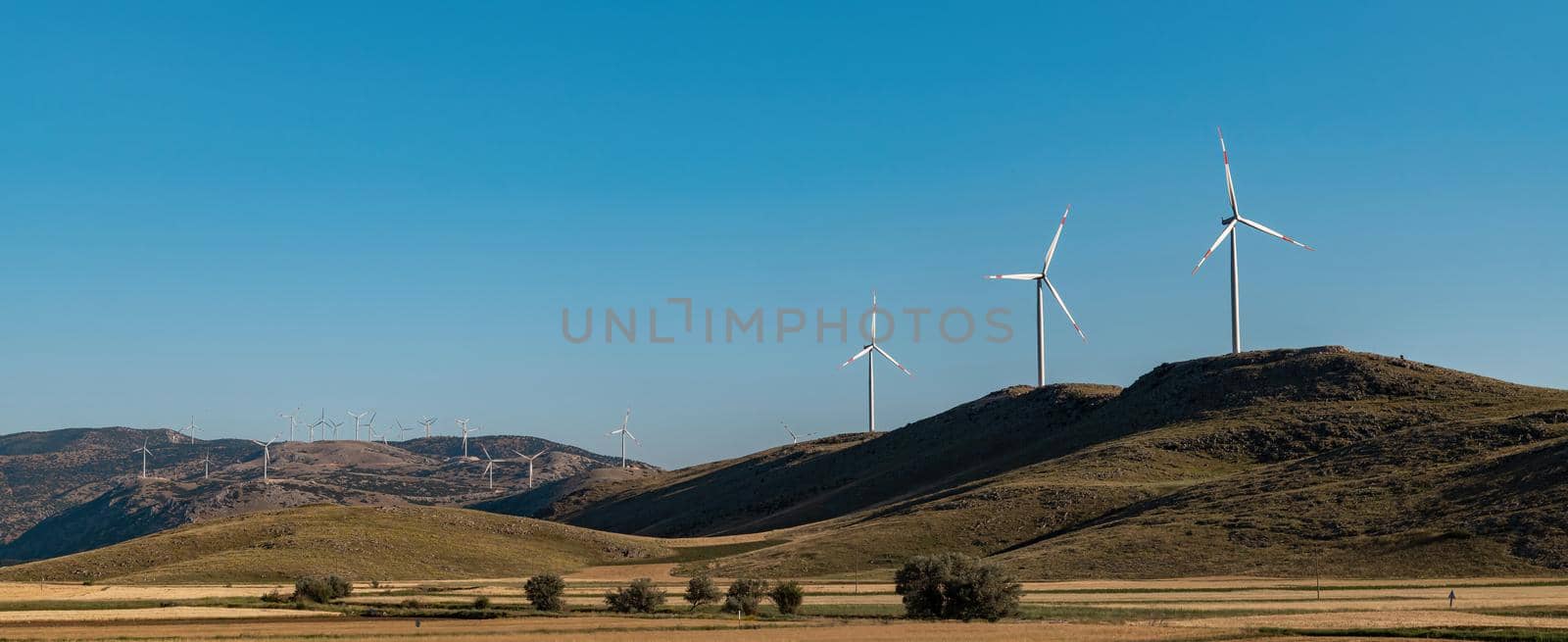 clean electricity producing wind turbine or windmill built on a windy mountain ridge by Sonat