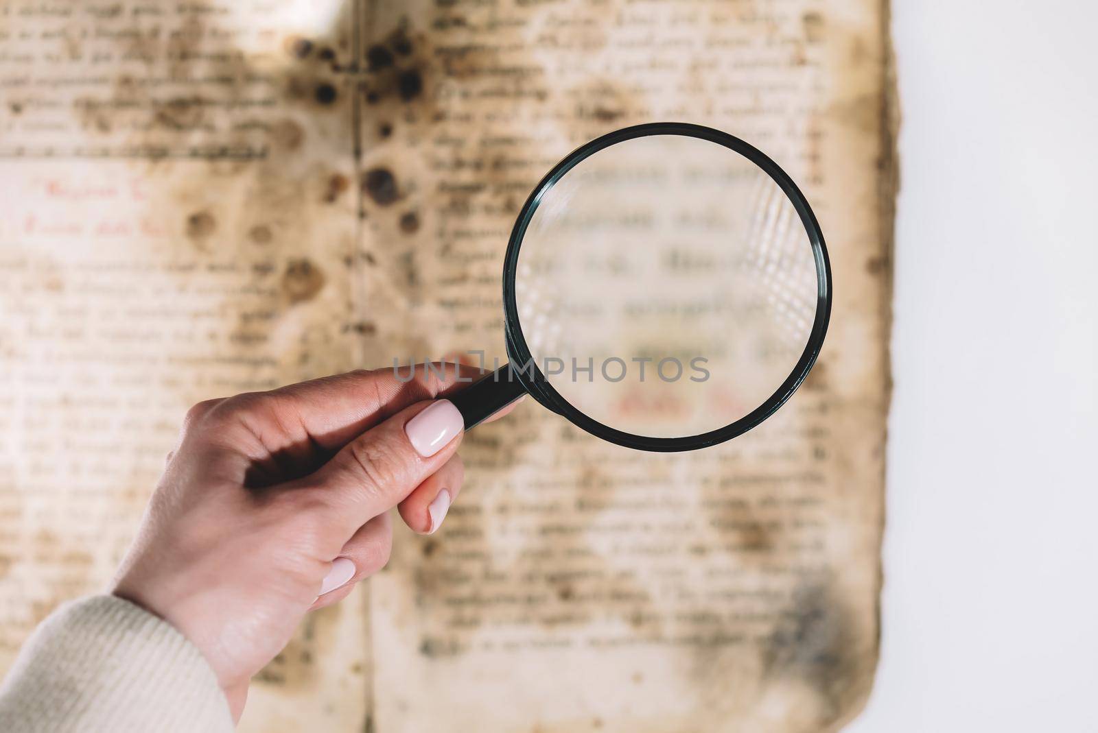 Historian scientist reading antique book with magnifying glass. Translation of religious literature. Manuscript with ancient writings. Treasures of the past. Museum piece