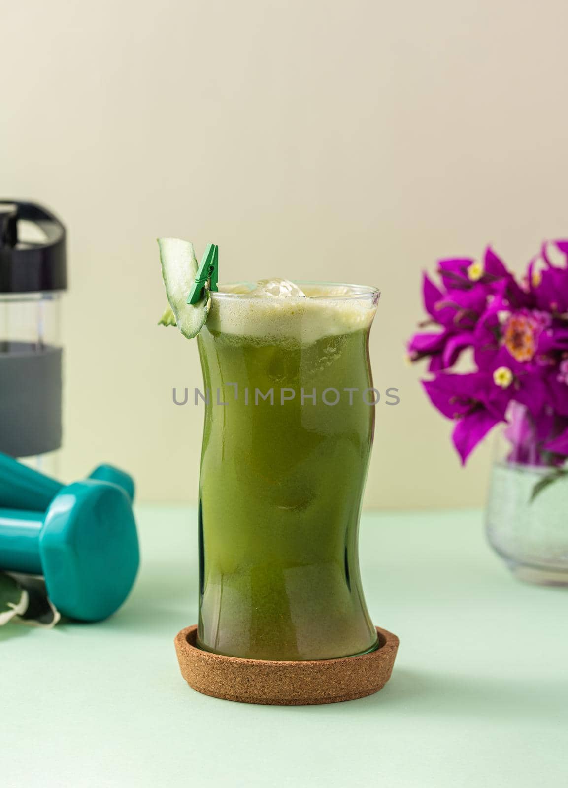 Vegetable smoothie, healthy organic juice made from celery, green apples, leaves of spinach and young carrot. Glass of green juice.