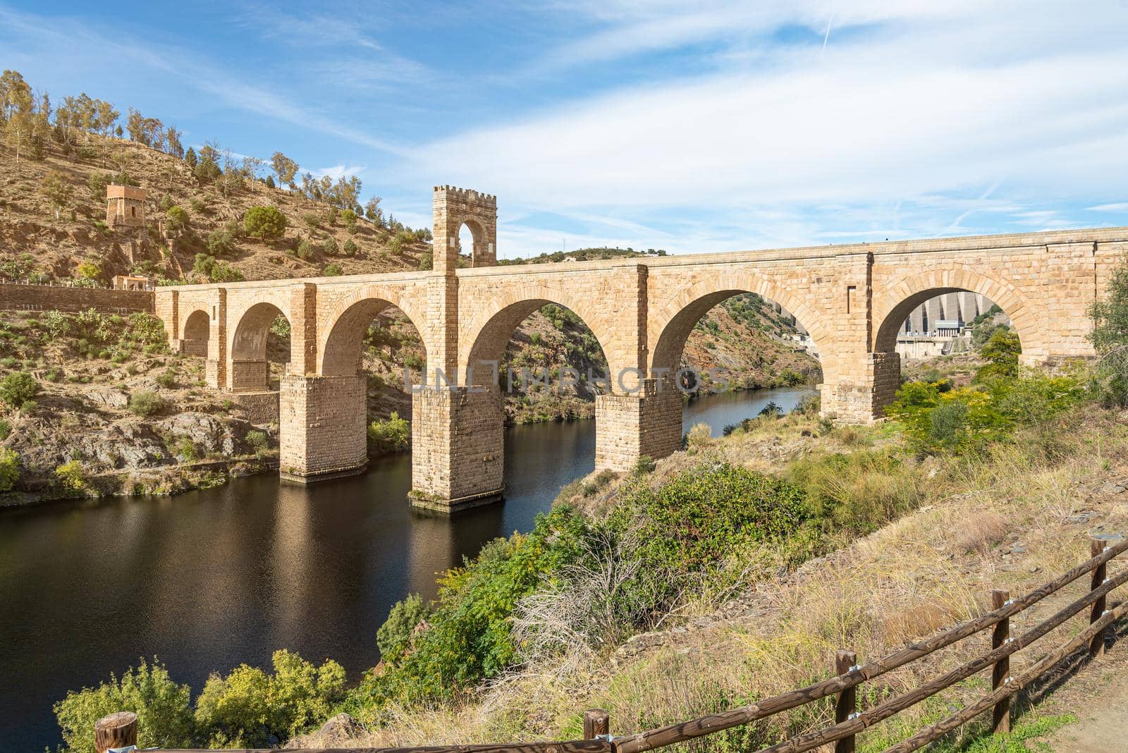 Stone old bridge over river in summertime by ivanmoreno