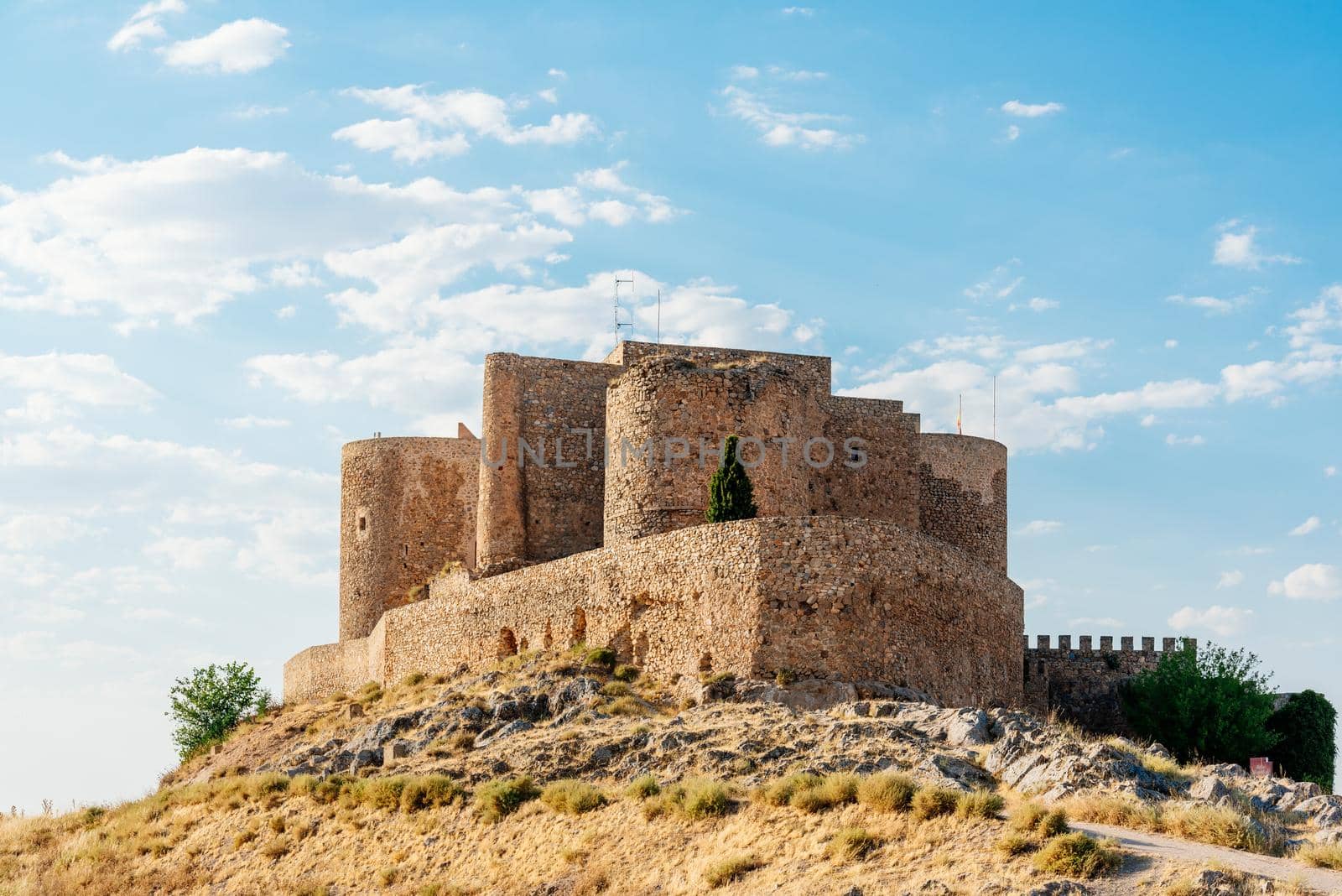 Restored medieval castle and walls on a hill by ivanmoreno