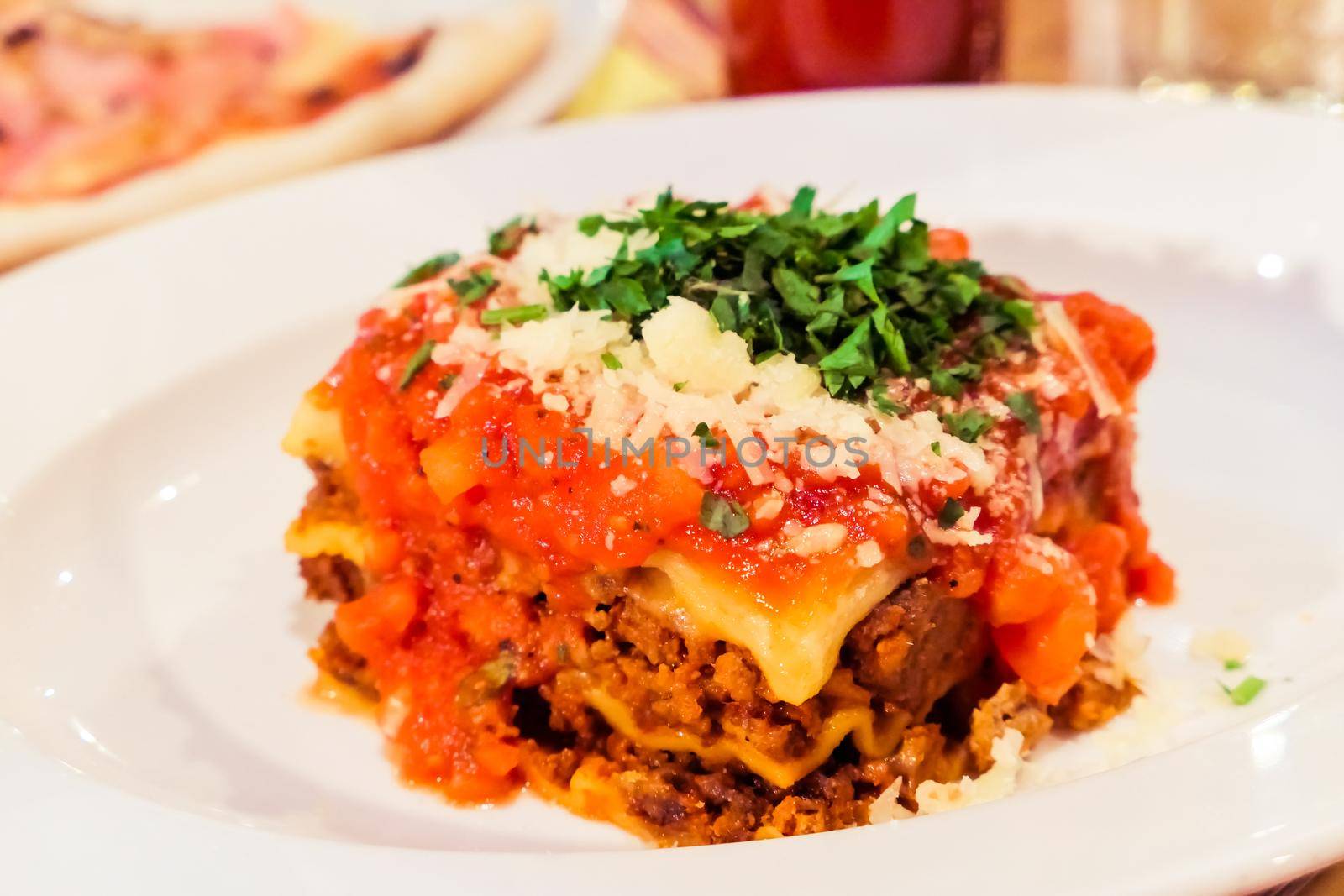 Lasagna bolognese plate, traditional recipe with tomato sauce, cheese and meat by Anneleven